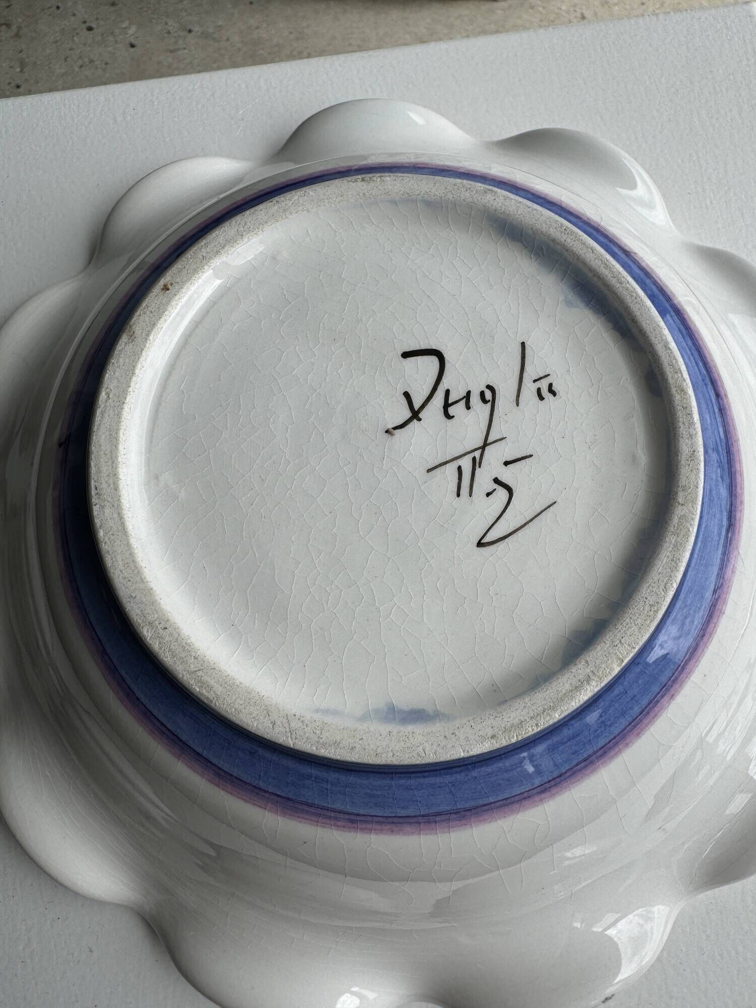Small hand-painted earthenware salad bowl with garland of blue flowers, mark below
