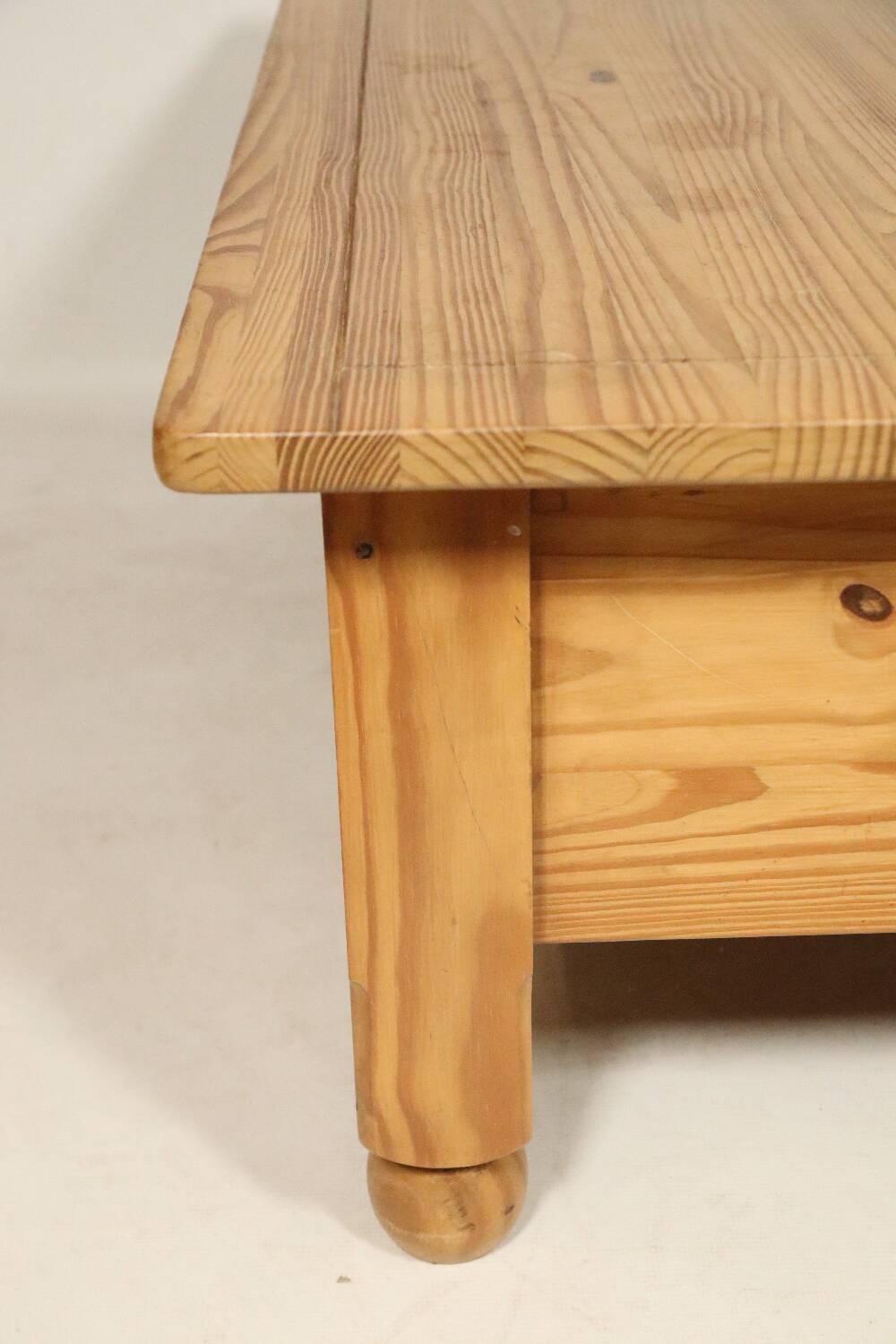 Rustic vintage style coffee table in light wood, mid-century modern design.