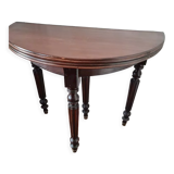 Family half-moon table in walnut hue.