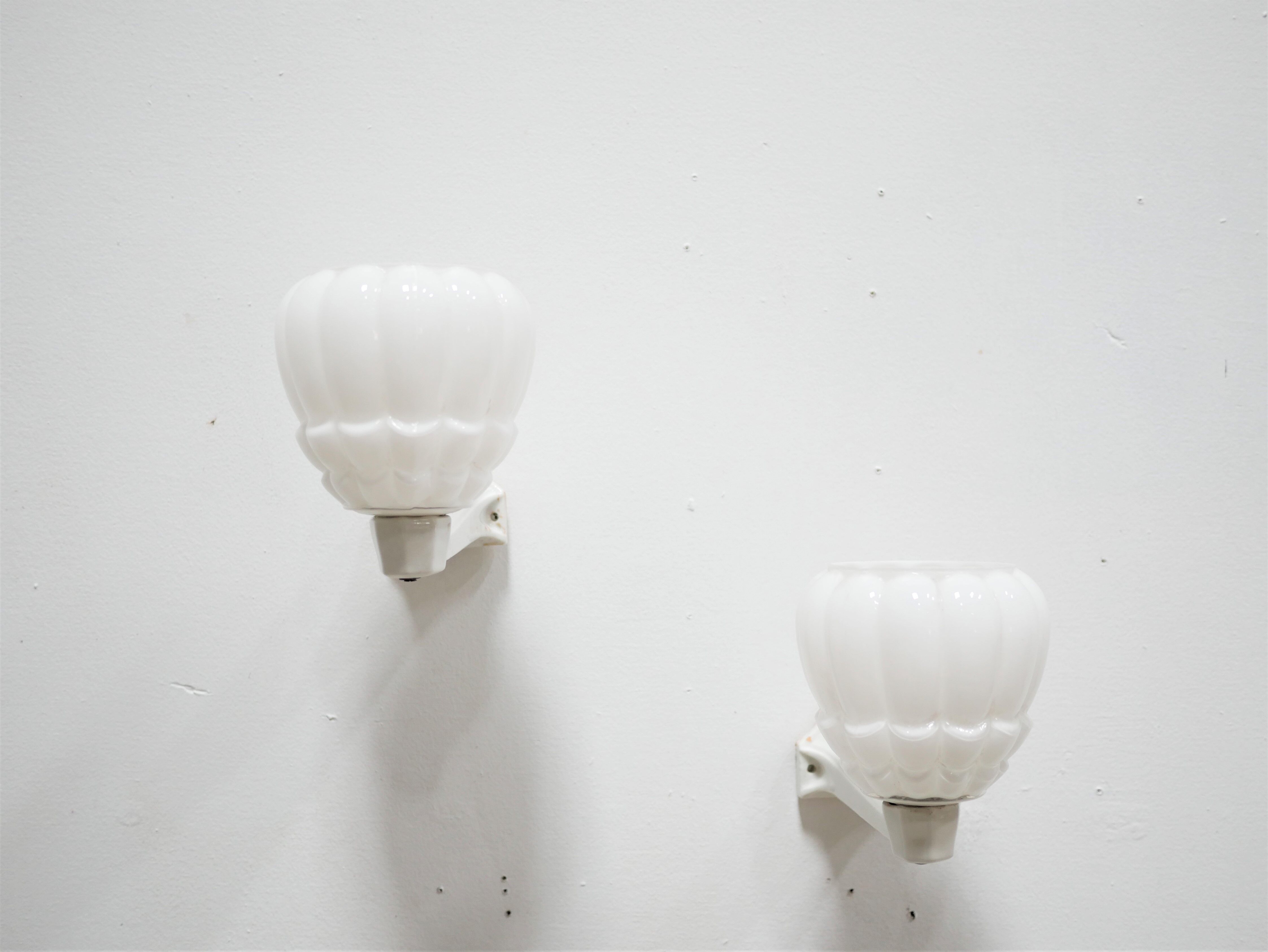 Pair of art deco porcelain and glass wall appliques
