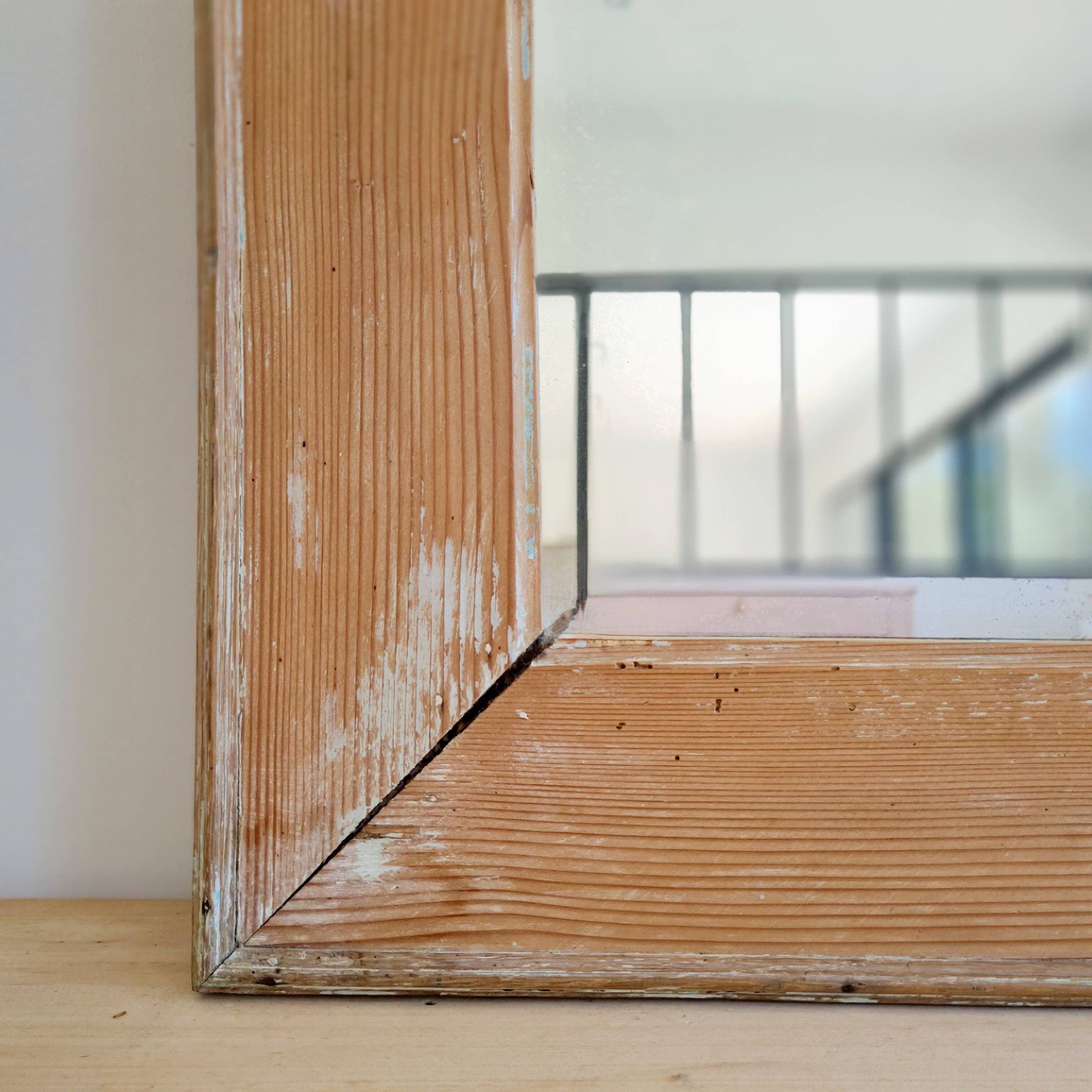 Antique mirror in raw wood with a patina and pediment.