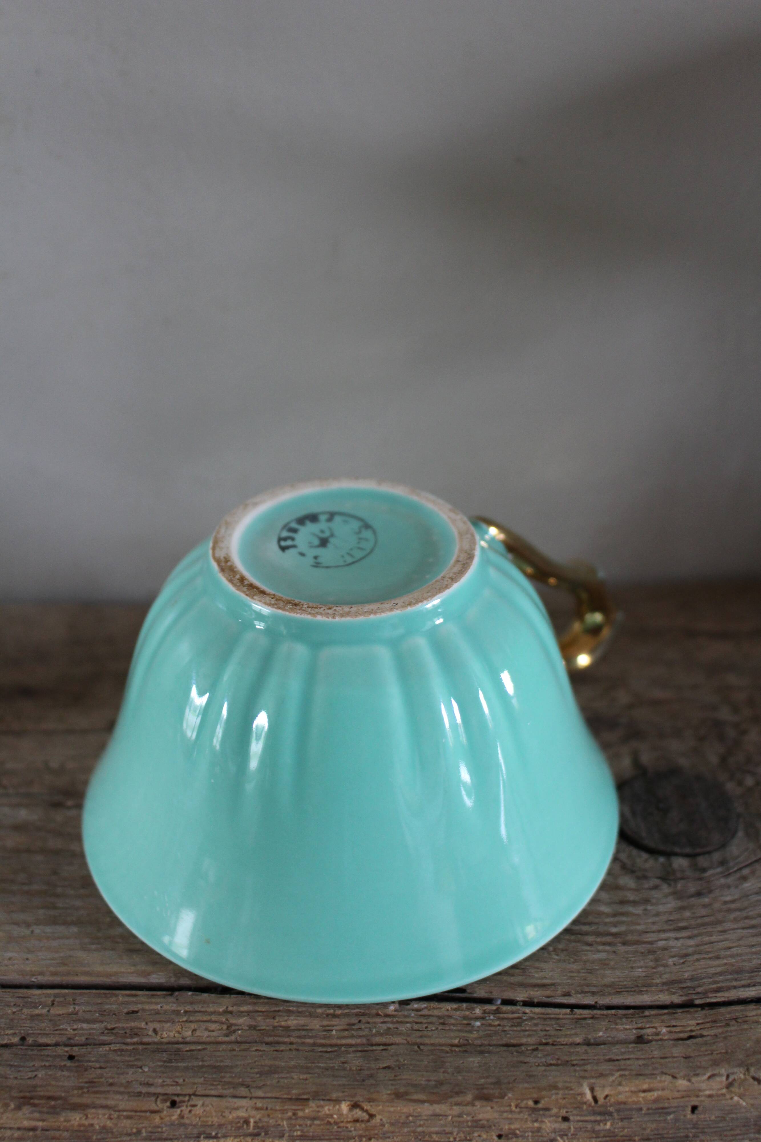Green and gold cup from the Moi Salins collection.