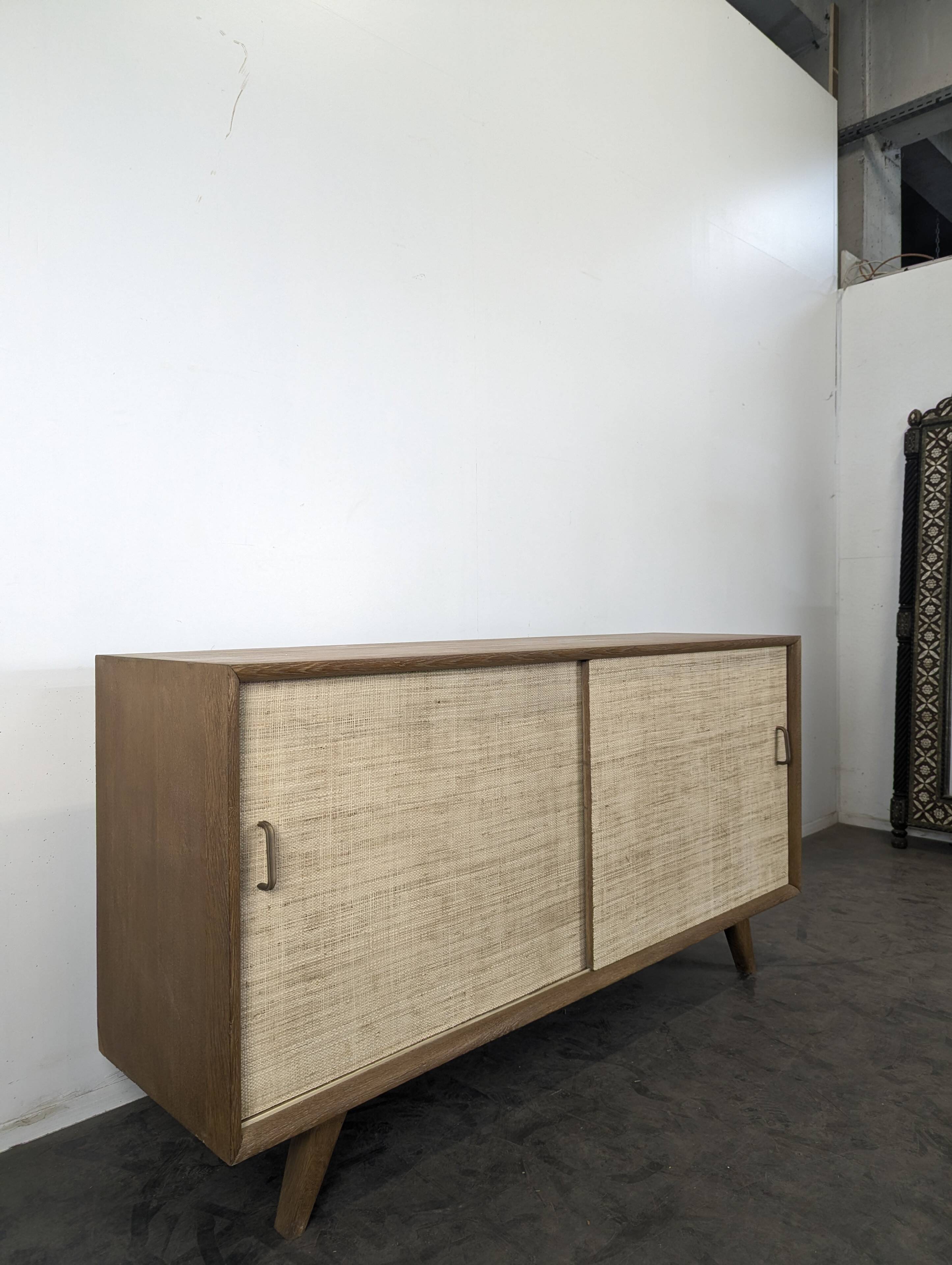 Modernist sideboard in oak with rattan doors.