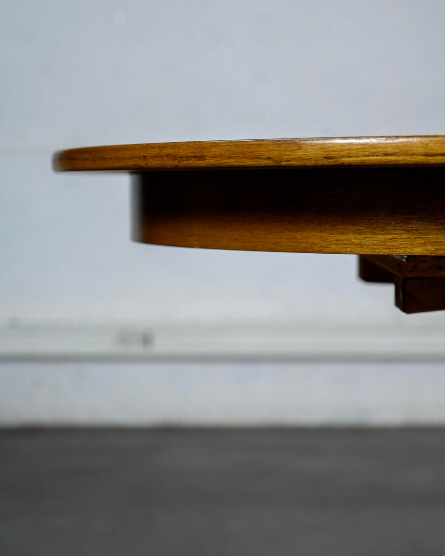 Round teak table with an extension.