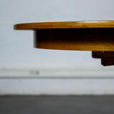 Round teak table with an extension.