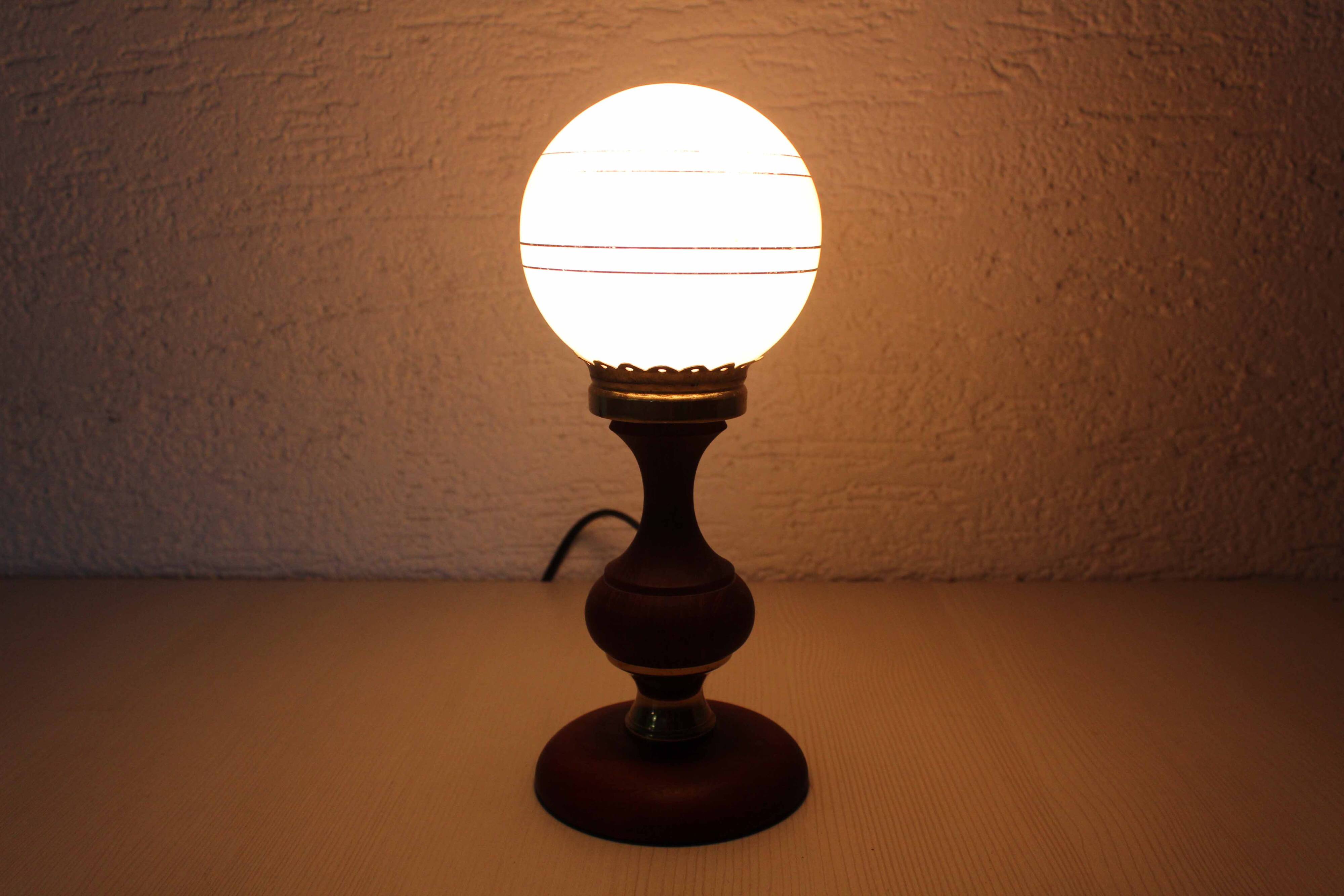 Turned wood and pink glass lamp
