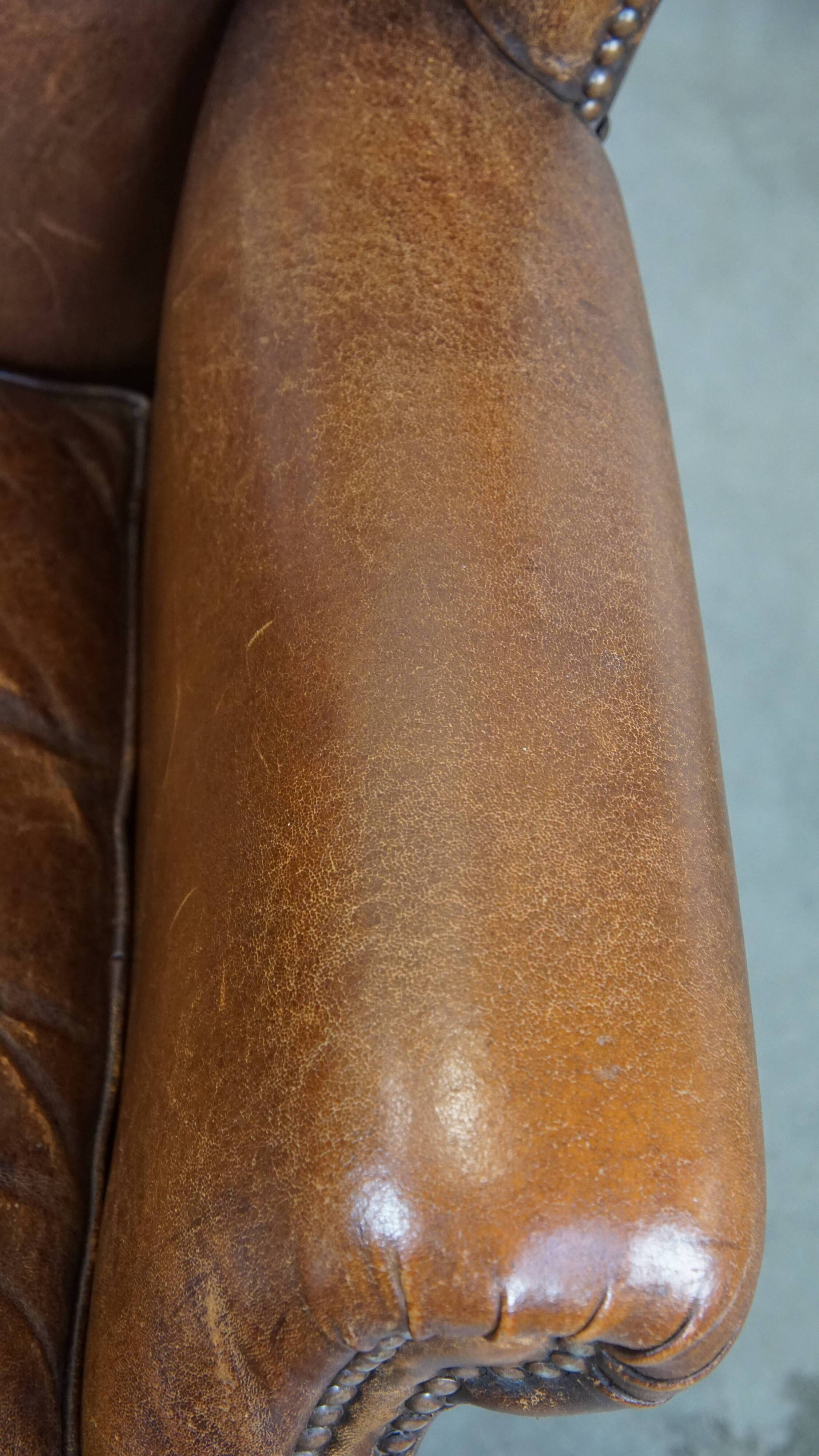 Cognac-colored sheepskin wing chair in English style