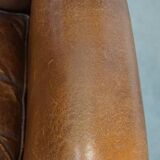 Cognac-colored sheepskin wing chair in English style