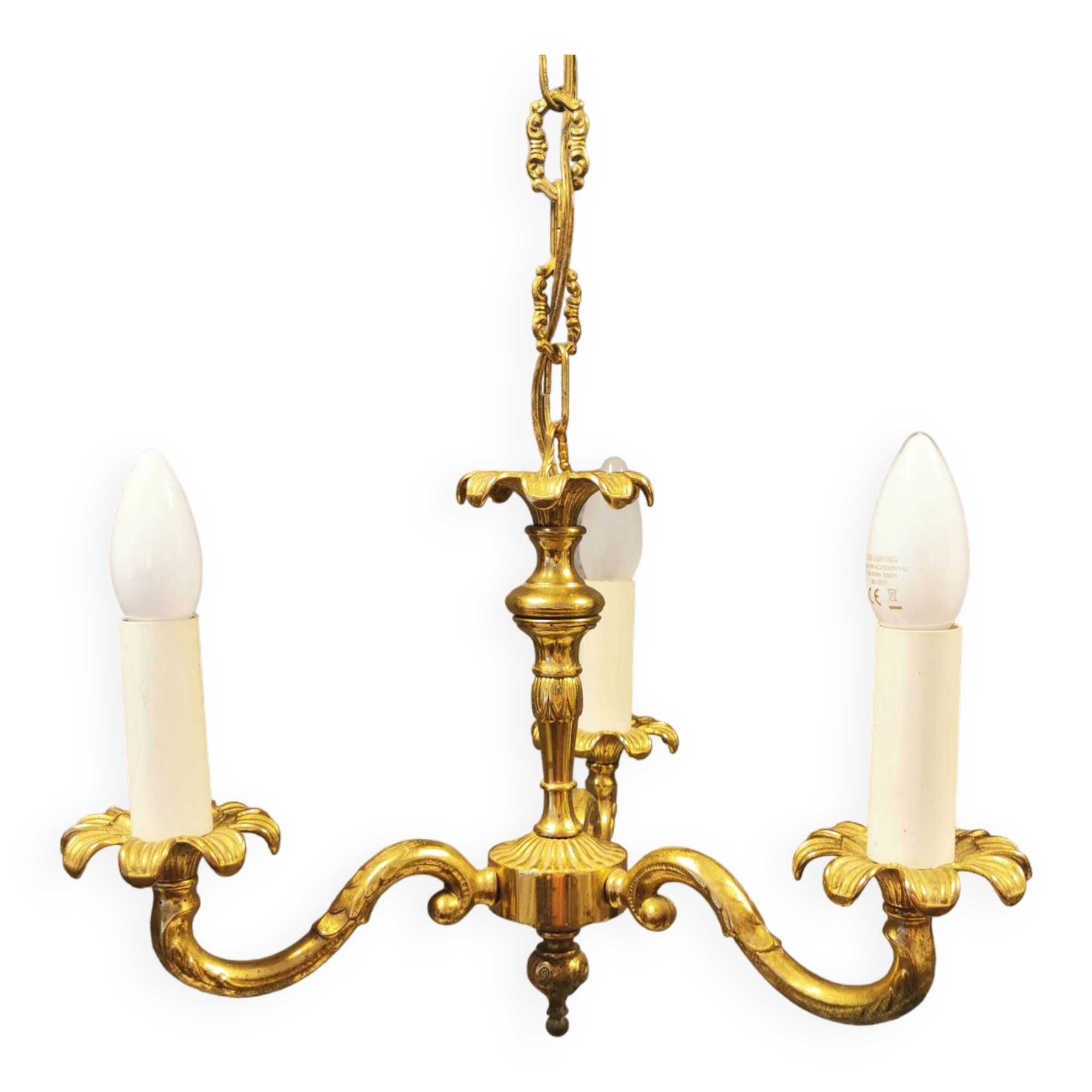 Older brass alloy chandelier with three light sources.
