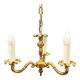 Older brass alloy chandelier with three light sources.
