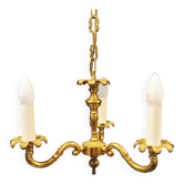 Lustre ancien en alliage de laiton à trois sources lumineuses.