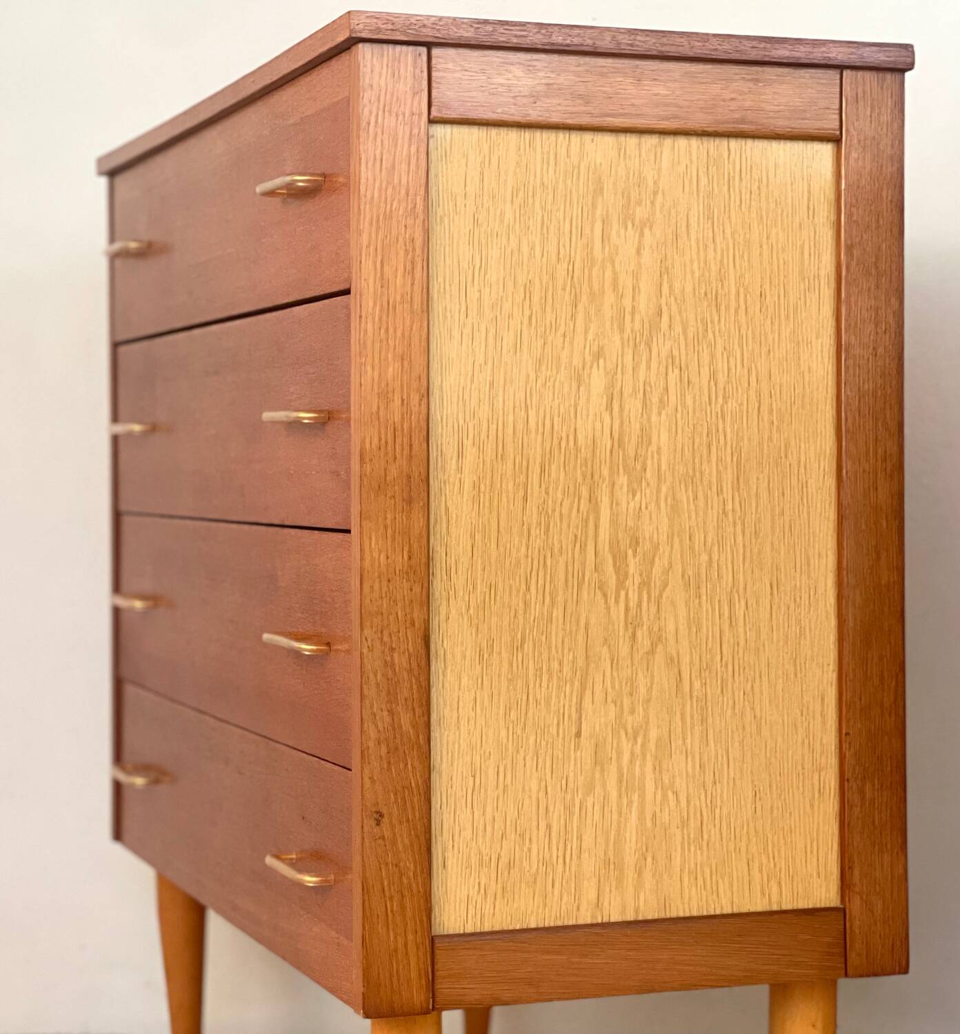 Vintage 1960s chest of drawers with covered handles.