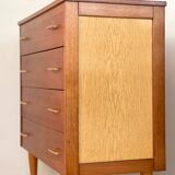 Vintage 1960s chest of drawers with covered handles.