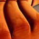 Burnt orange modular sofa for four with a futuristic design.