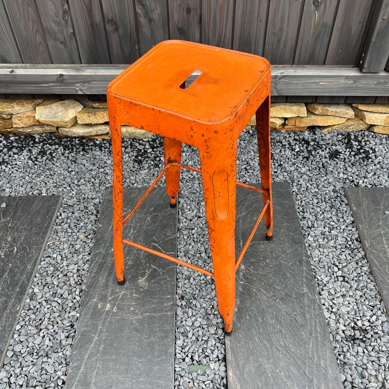 Orange metal workshop stool