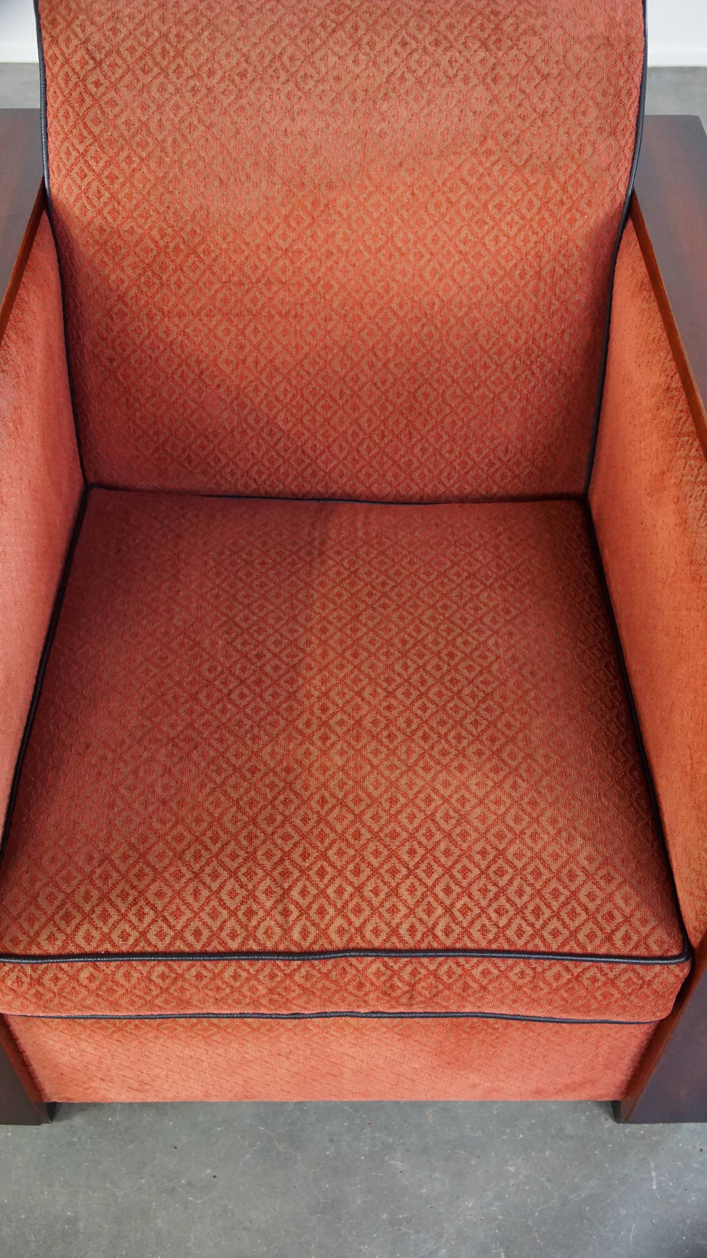 Art Deco design armchair with red fabric upholstery and wooden details