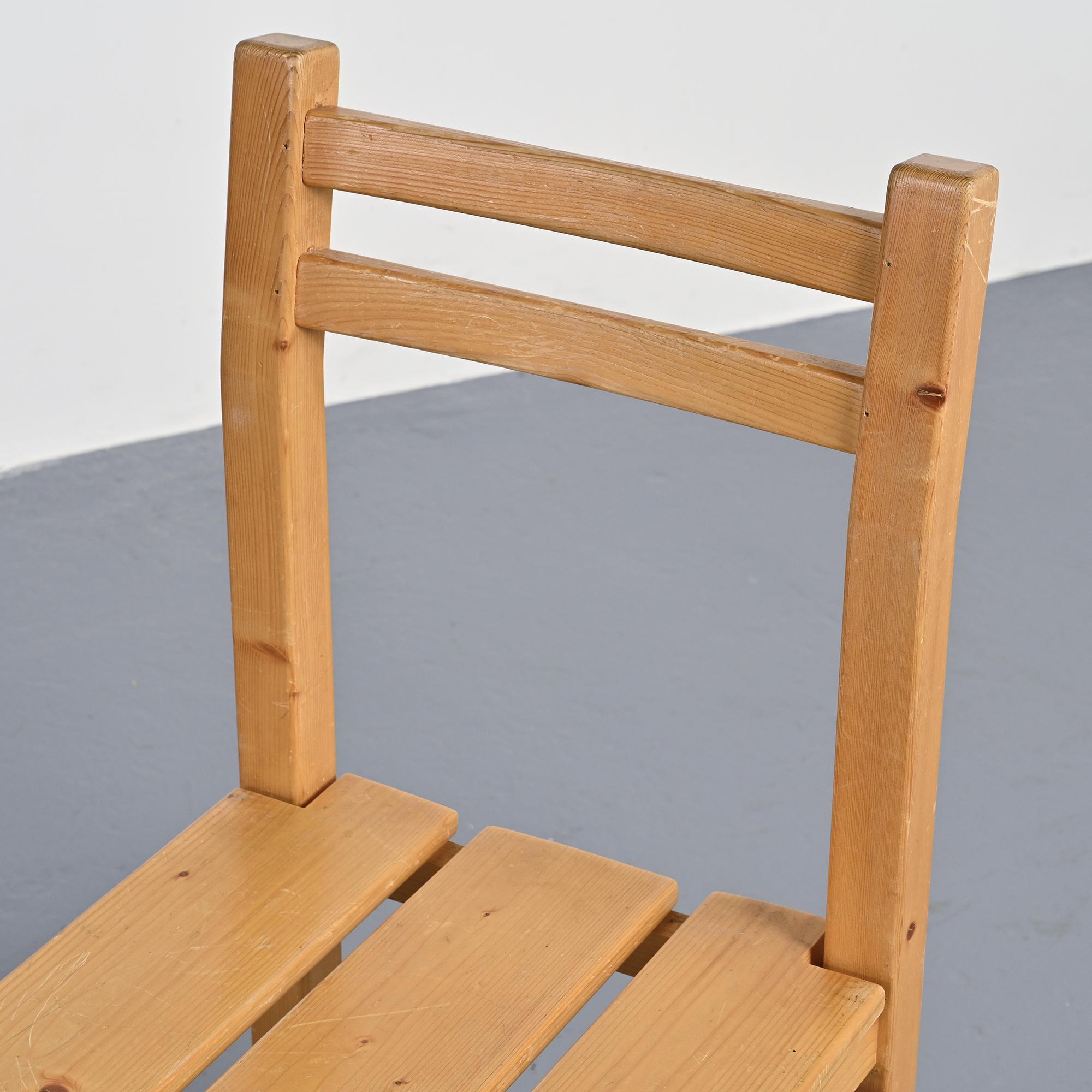 Set of four solid pine chairs by Maison Regain.