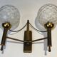 Pair of brass wall lights with glass globes. Around 1970.