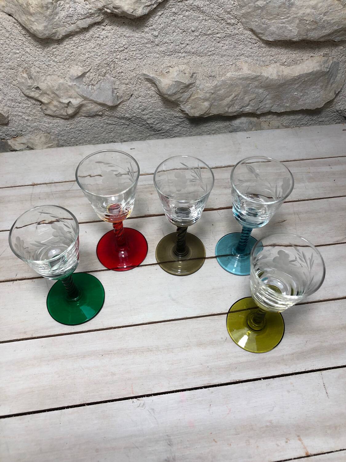 Antique and rare! Sold in a set of 12 colorful twisted stemmed glasses engraved with flowers and leaves