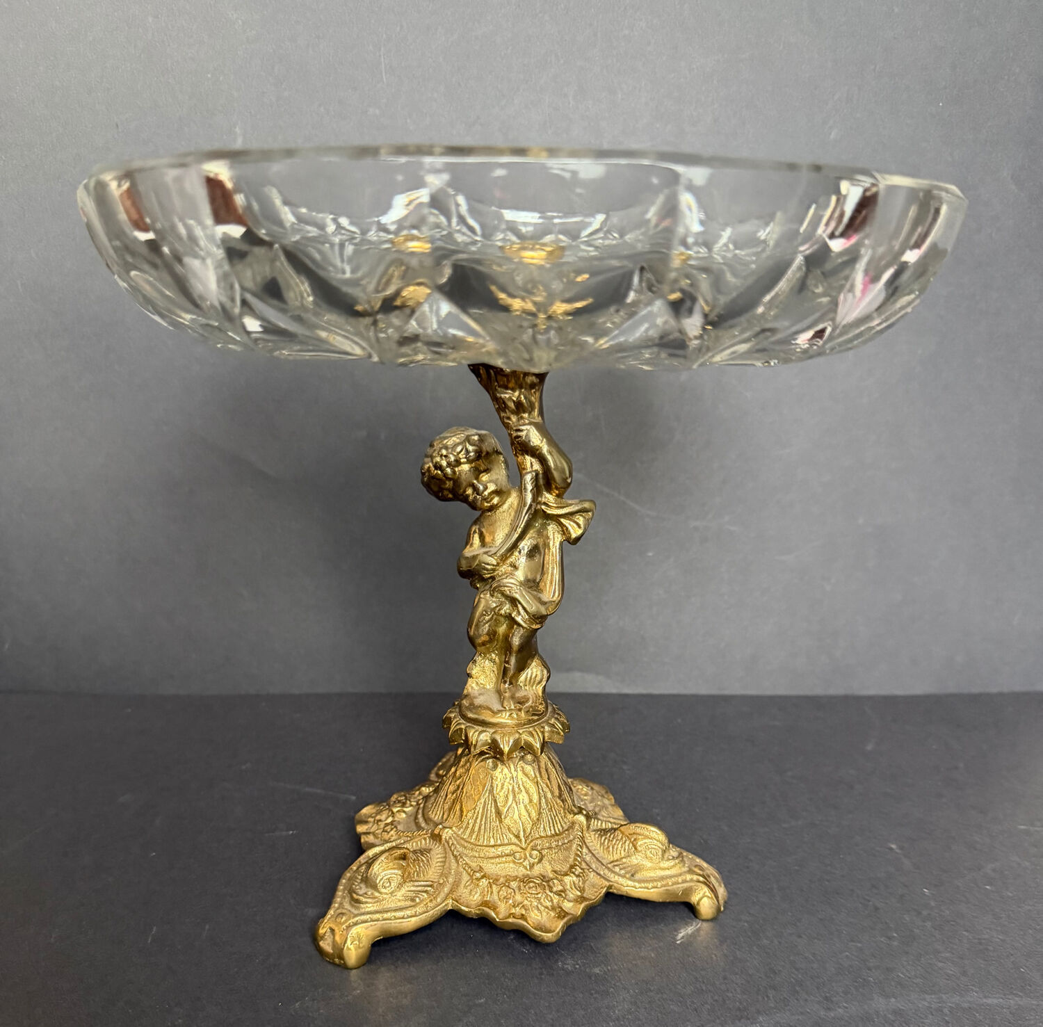 Antique crystal bowl on a bronze stand.