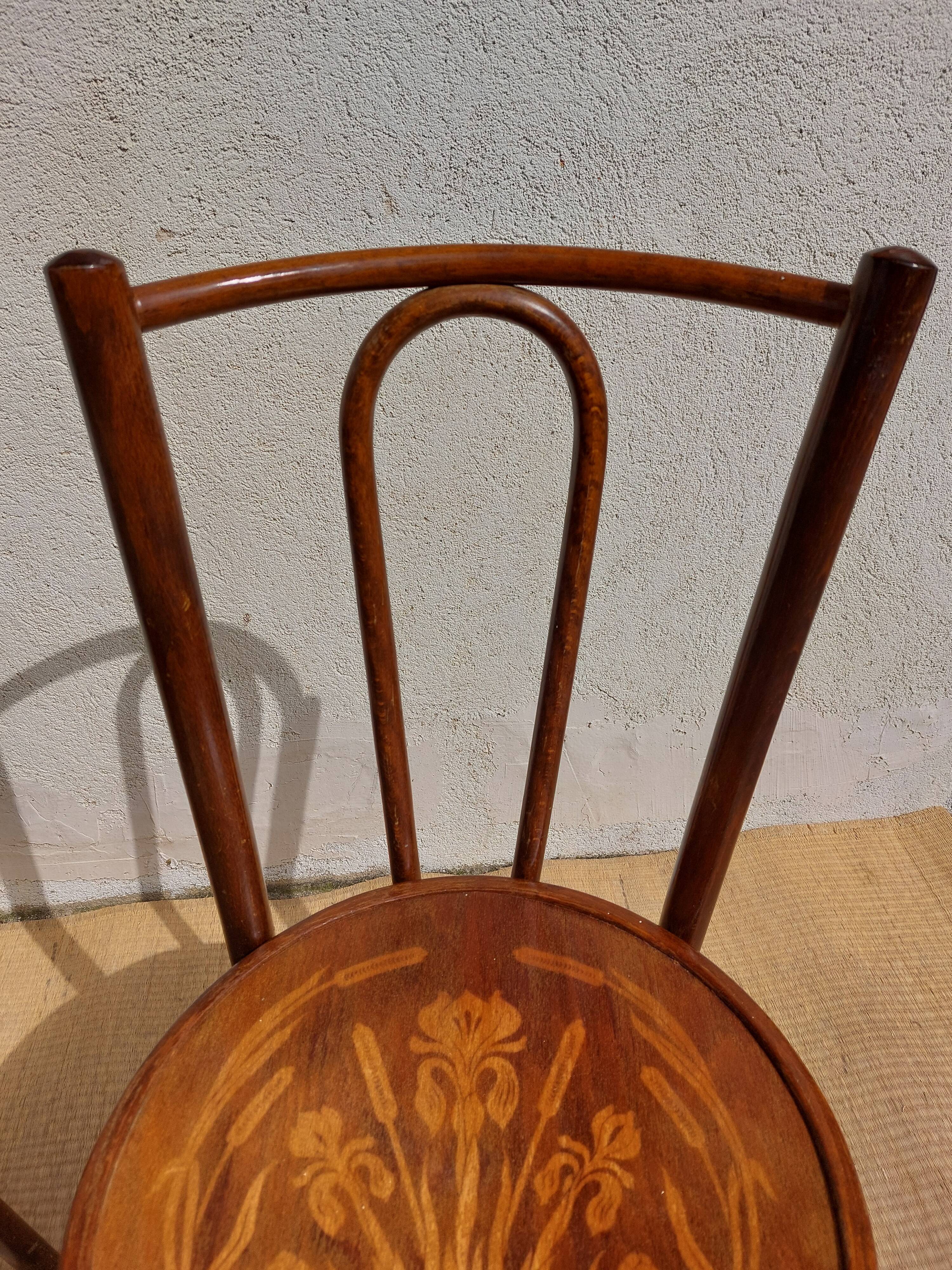 pair of bistro chairs, curved wood and pattern on the seat