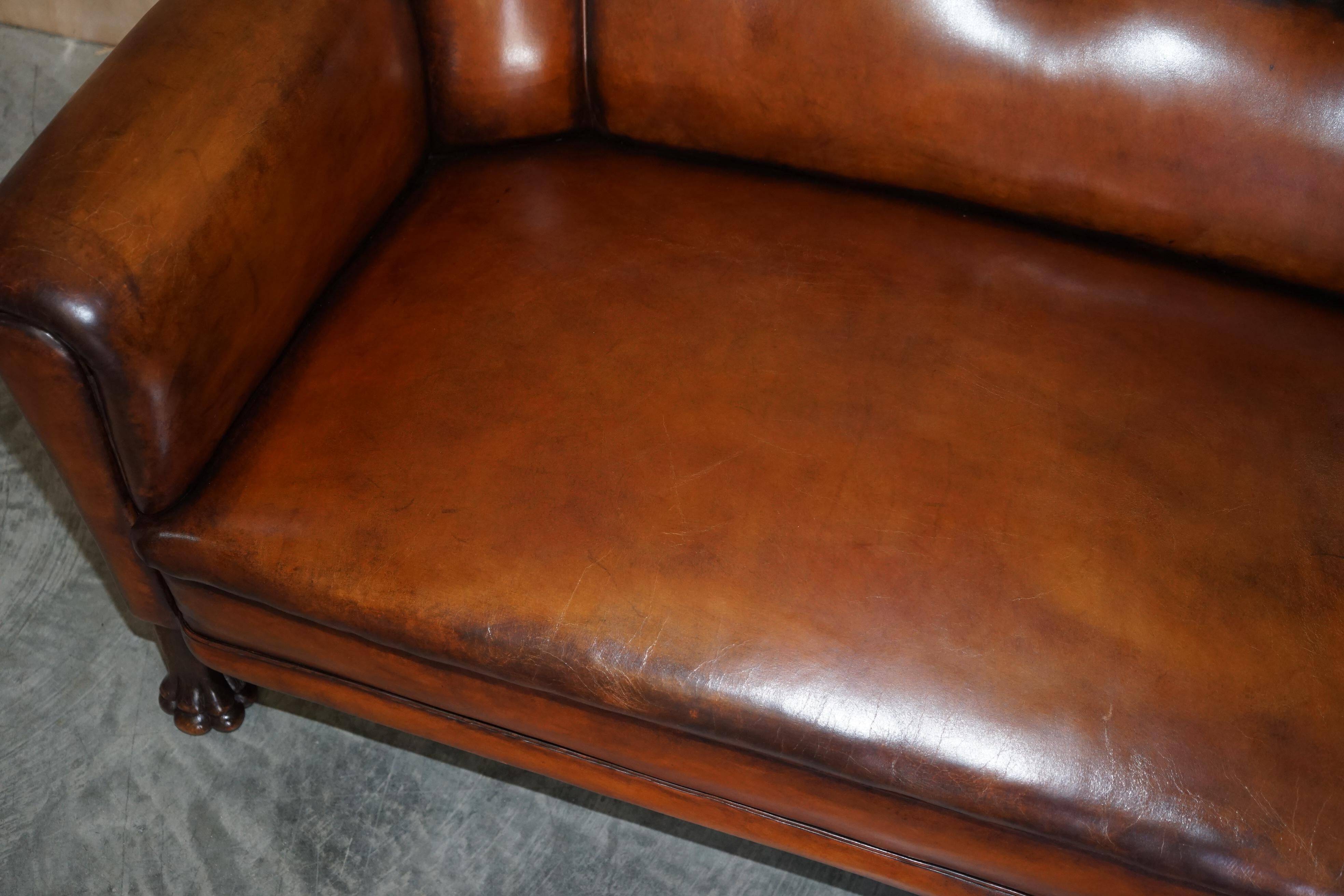 Victorian Chesterfield leather canapé with oak lion claw feet.