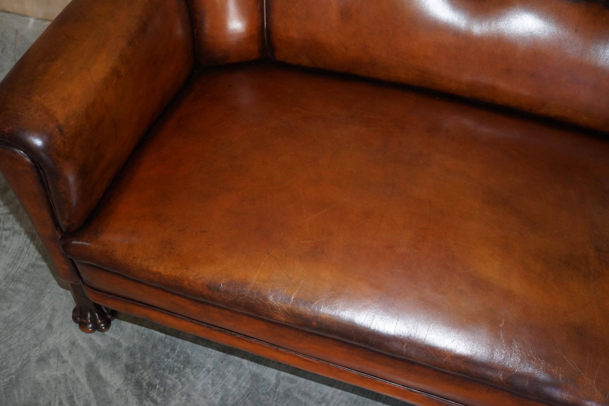 Victorian Chesterfield leather canapé with oak lion claw feet.