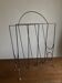 Mid-century poetic magazine rack in black metal