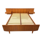 Double bed vintage Scandinavian in teak from the 1960s with integrated bedside tables.