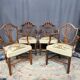 Set of four Sheraton-style armchairs. Solid walnut.