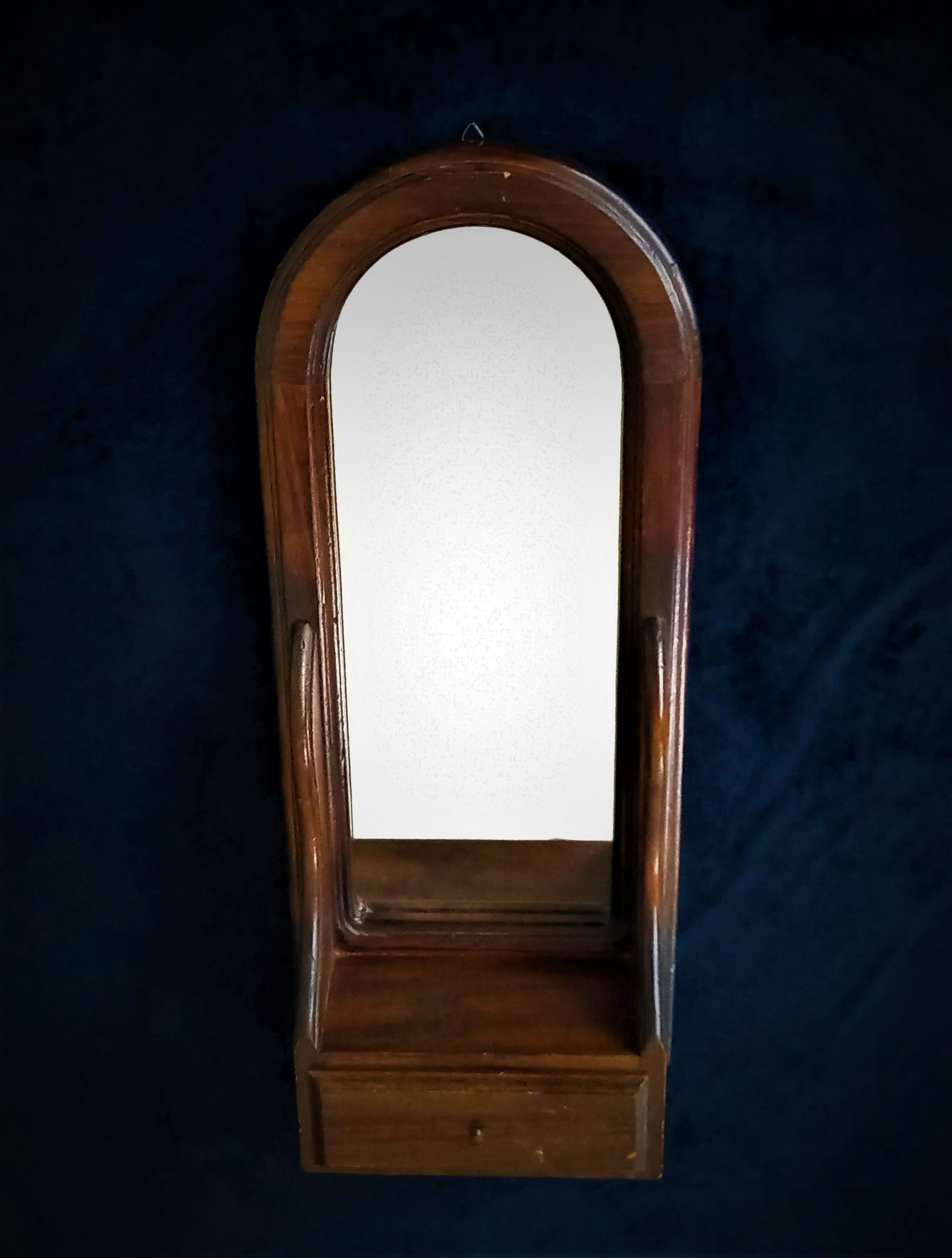 Wall mirror in arched frame with drawer