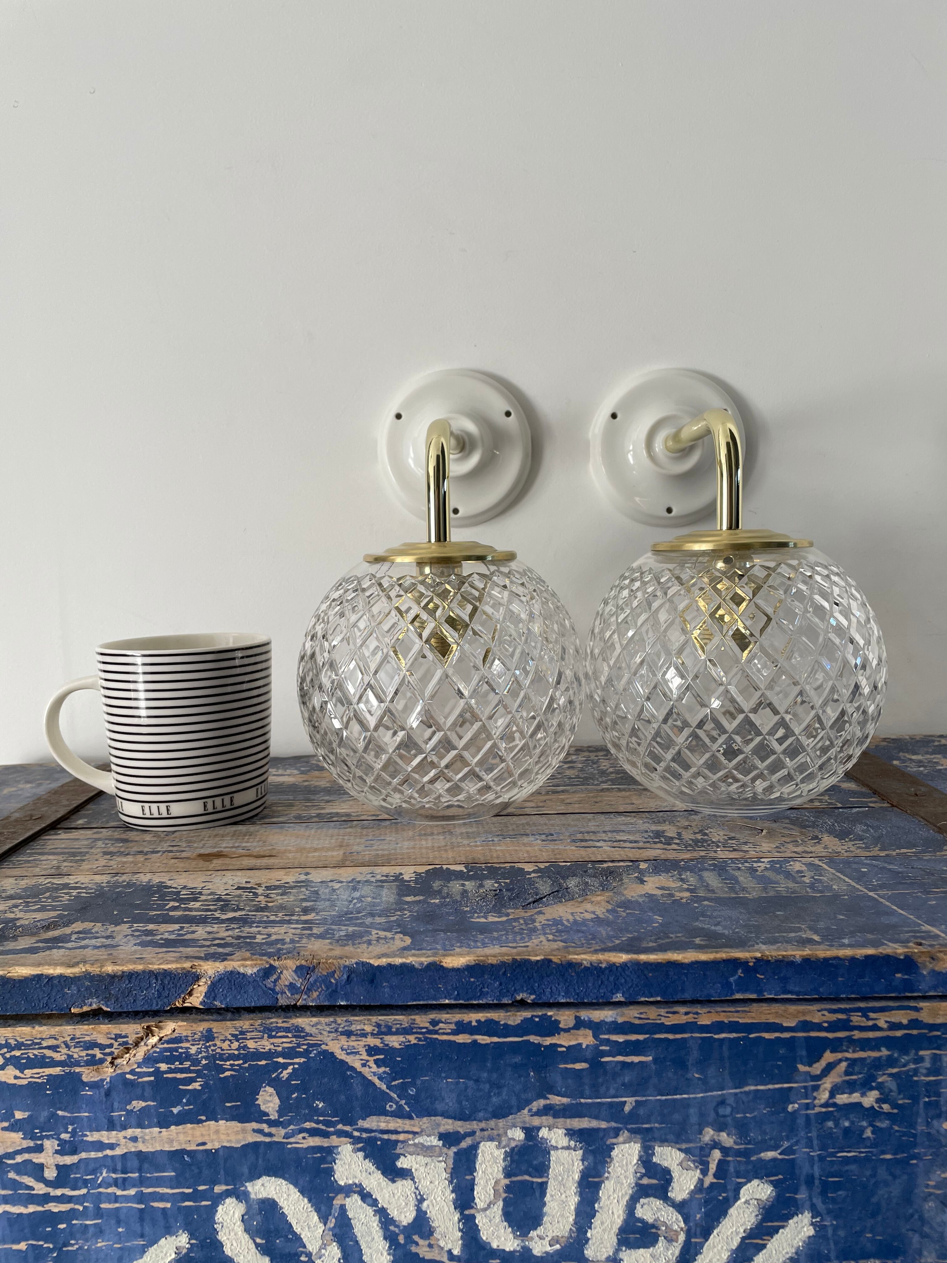 Set of two new electrified chiseled glass globe sconces
