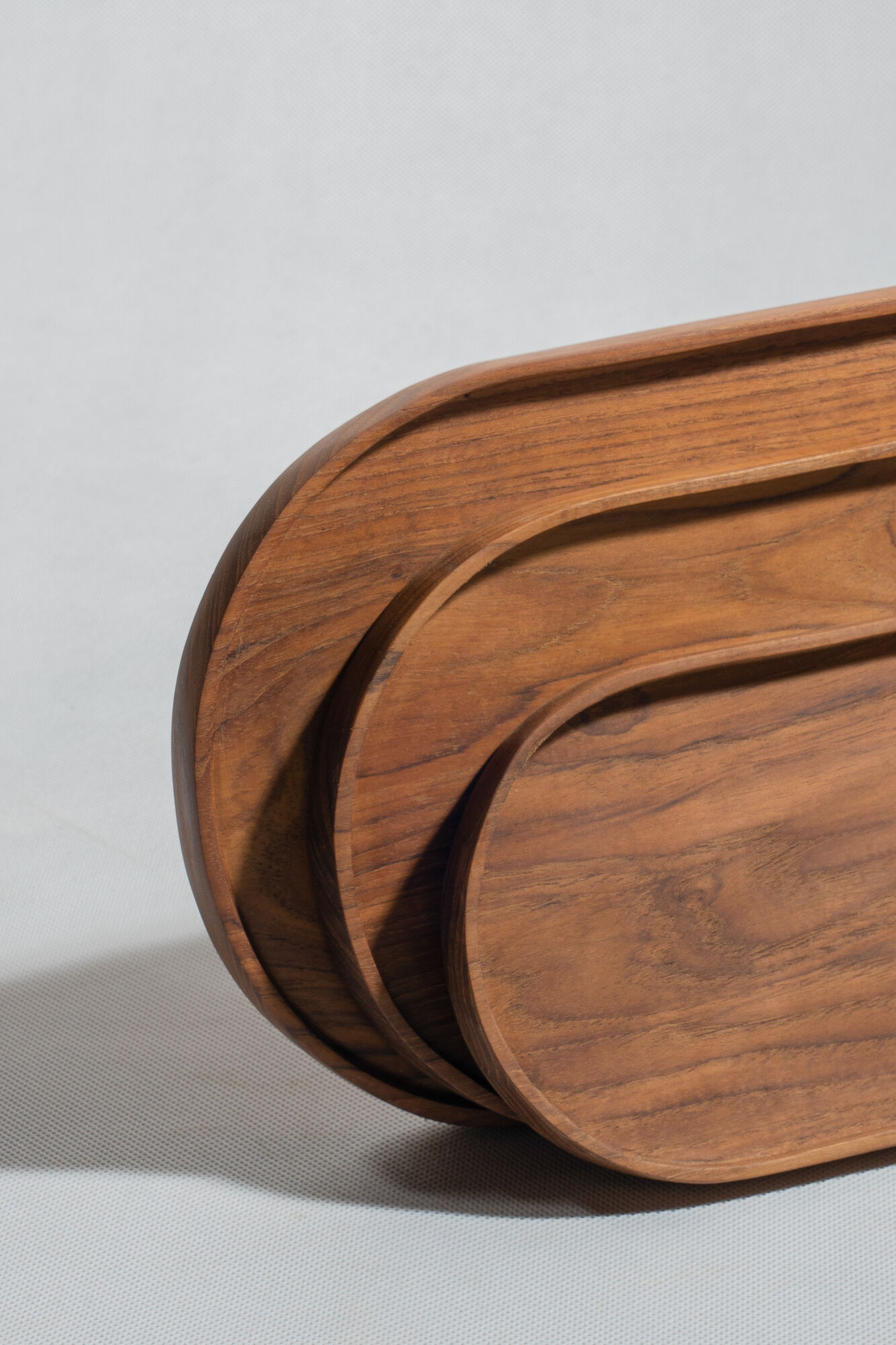 Trio of oval teak trays or cups
