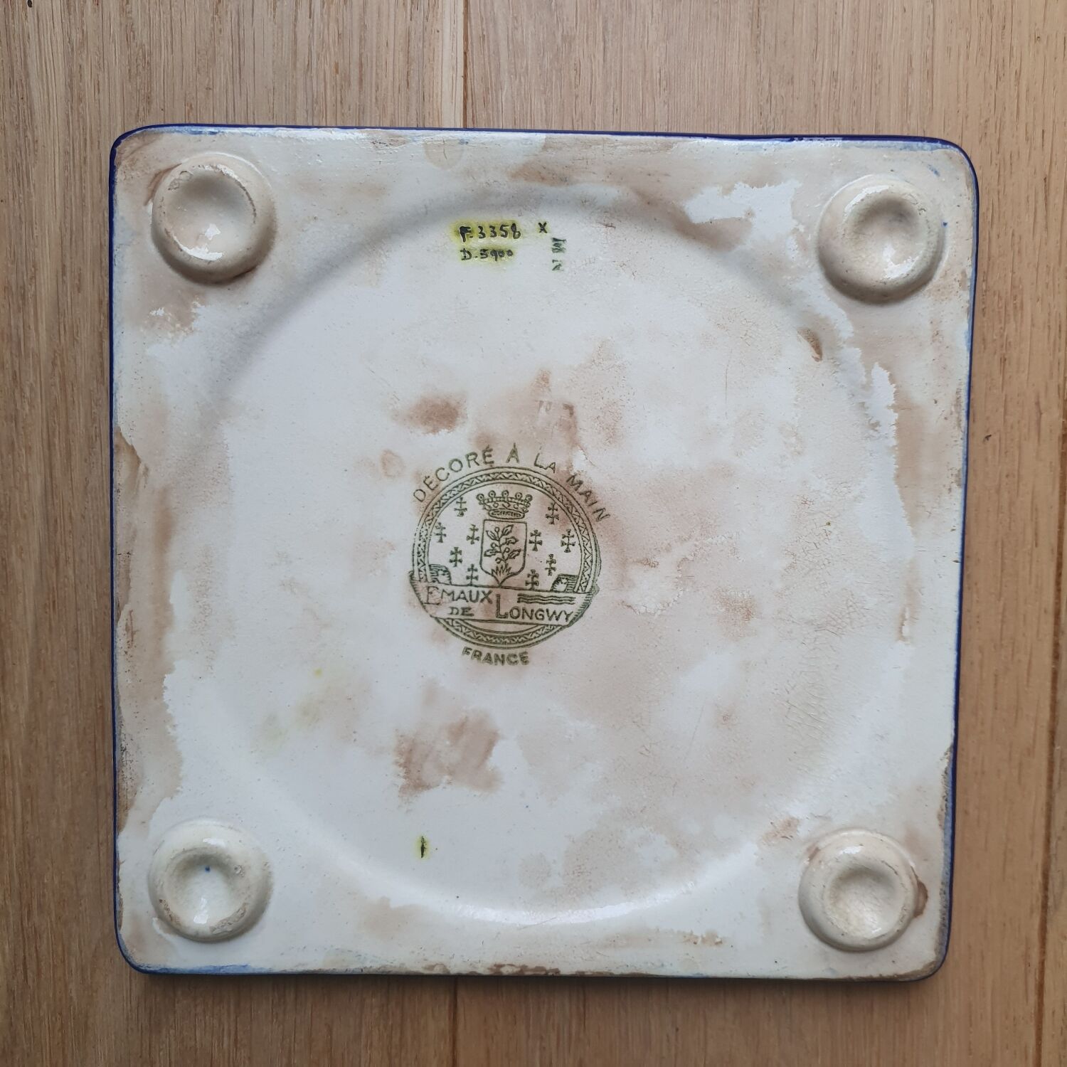 Trivet and Longwy enamel bottle