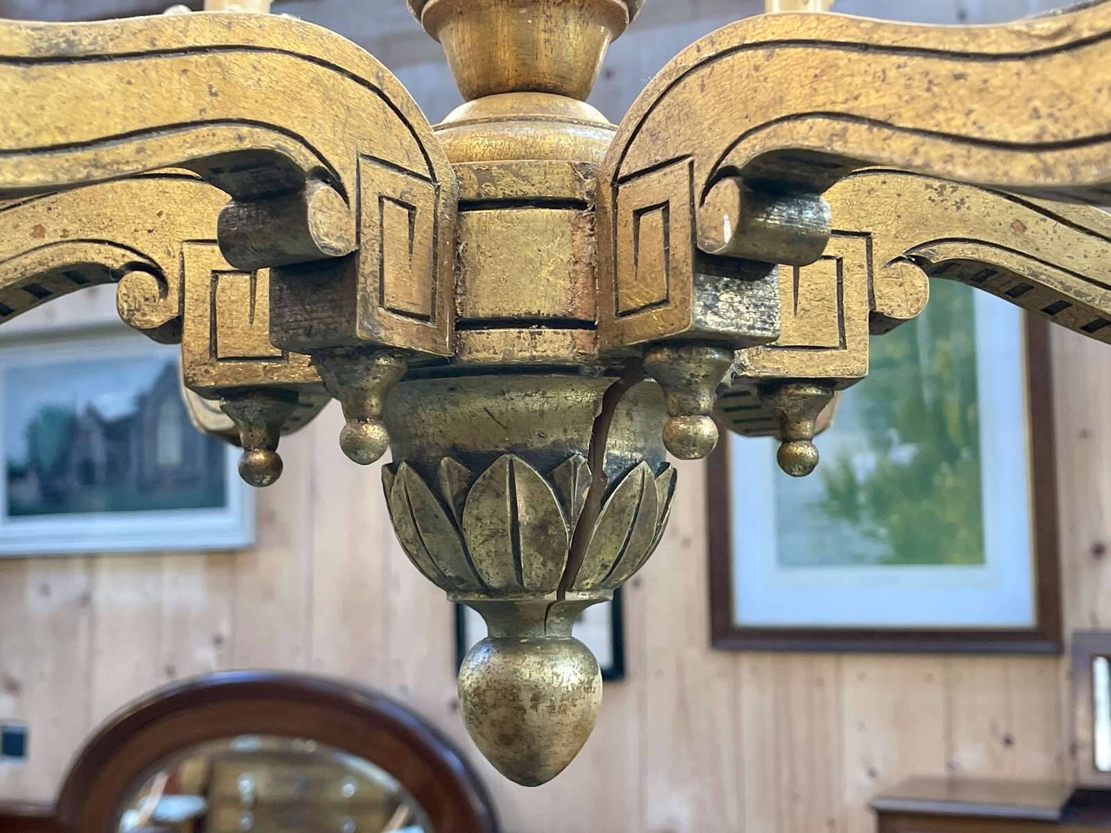 Golden wooden chandelier with crystal pendants from the 19th century.