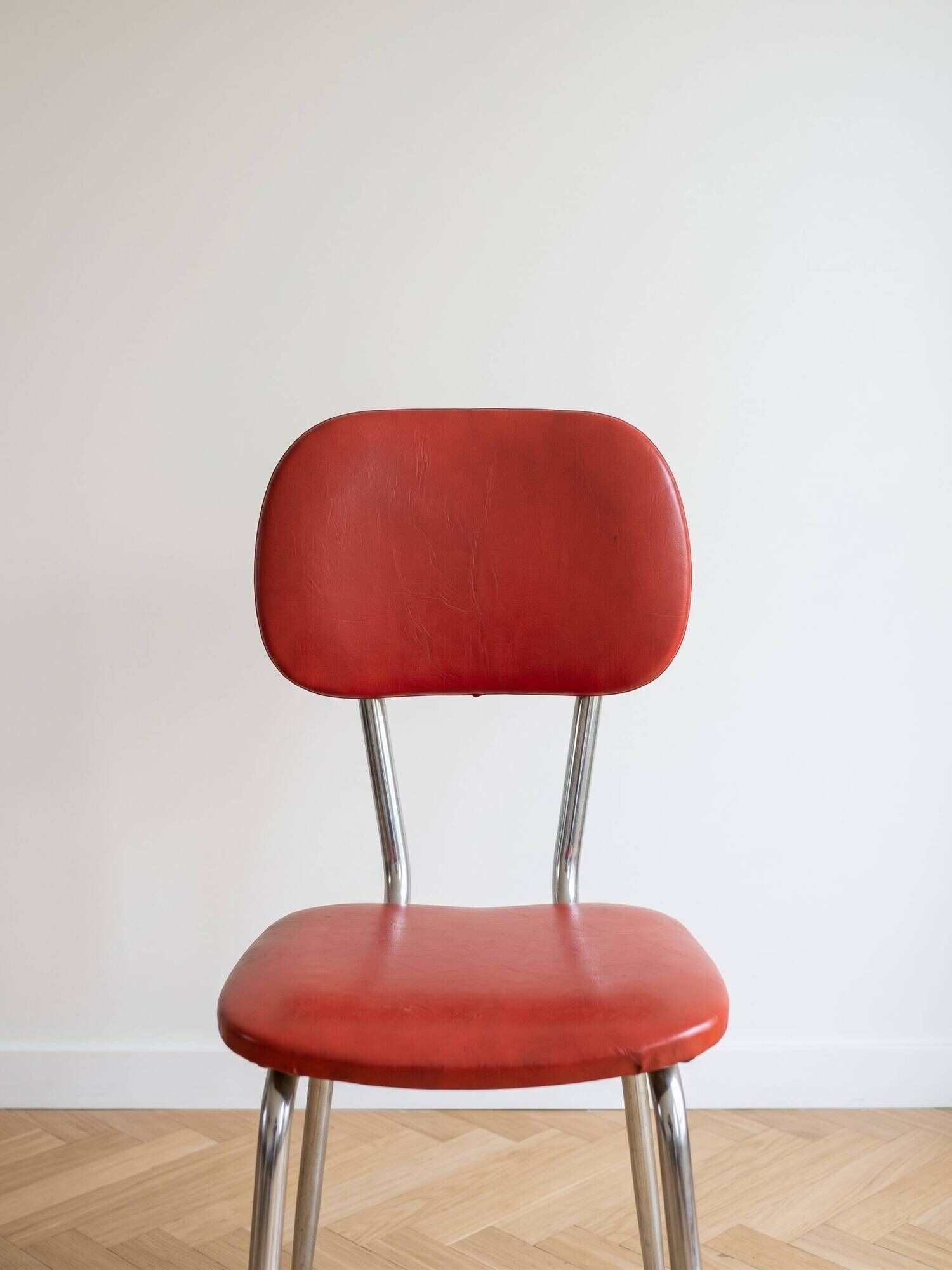 Set of 9 vintage retro chairs in red faux leather.