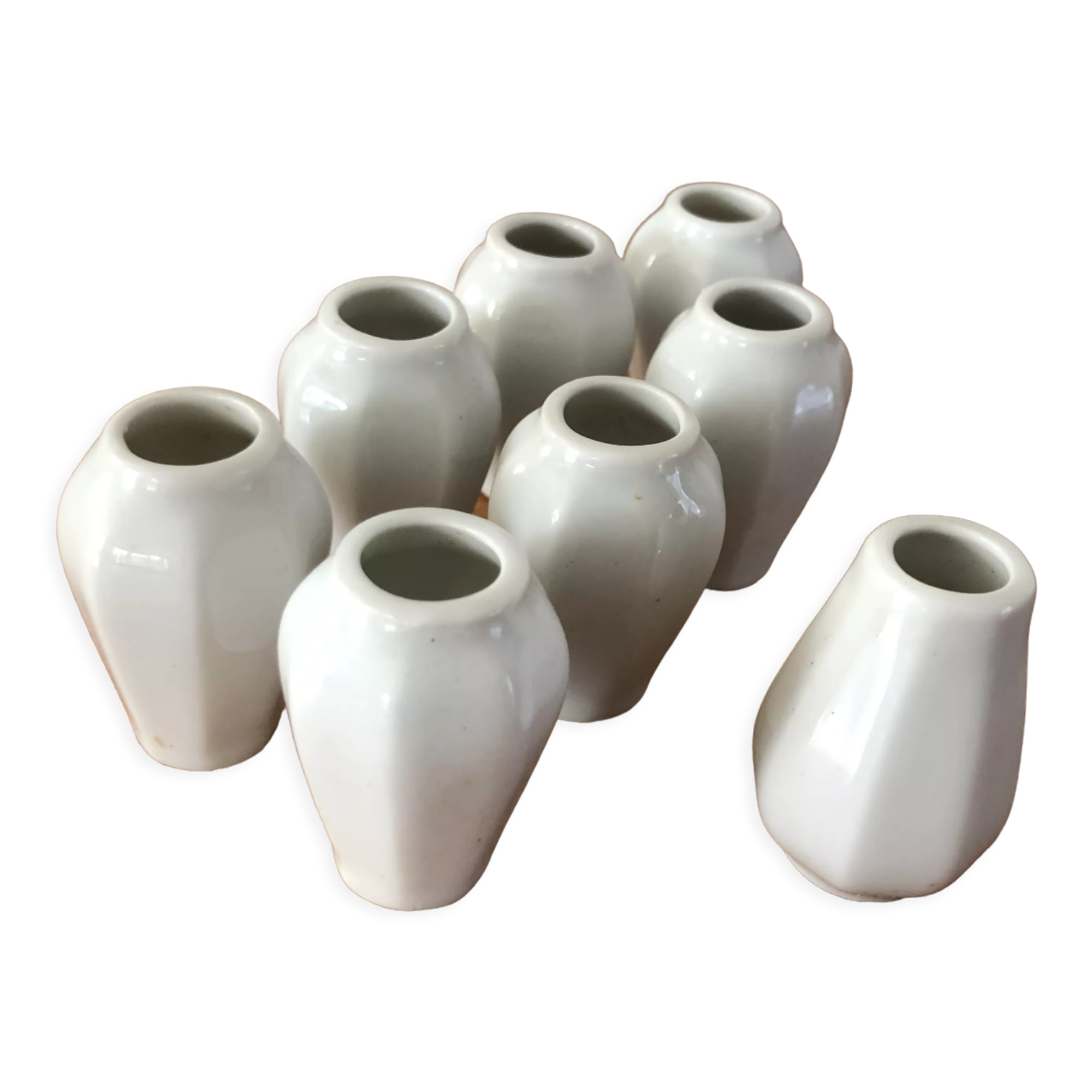 8 miniature vases in white earthenware