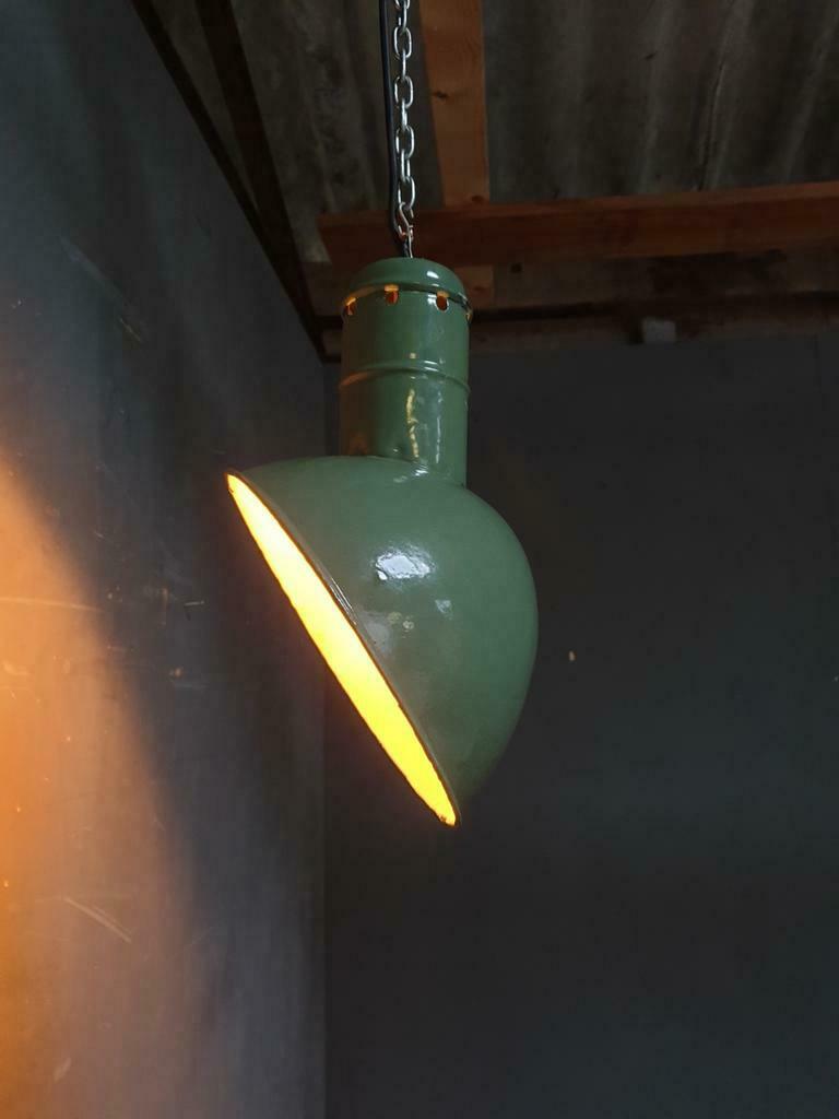 Old industrial enamel lamp in green
