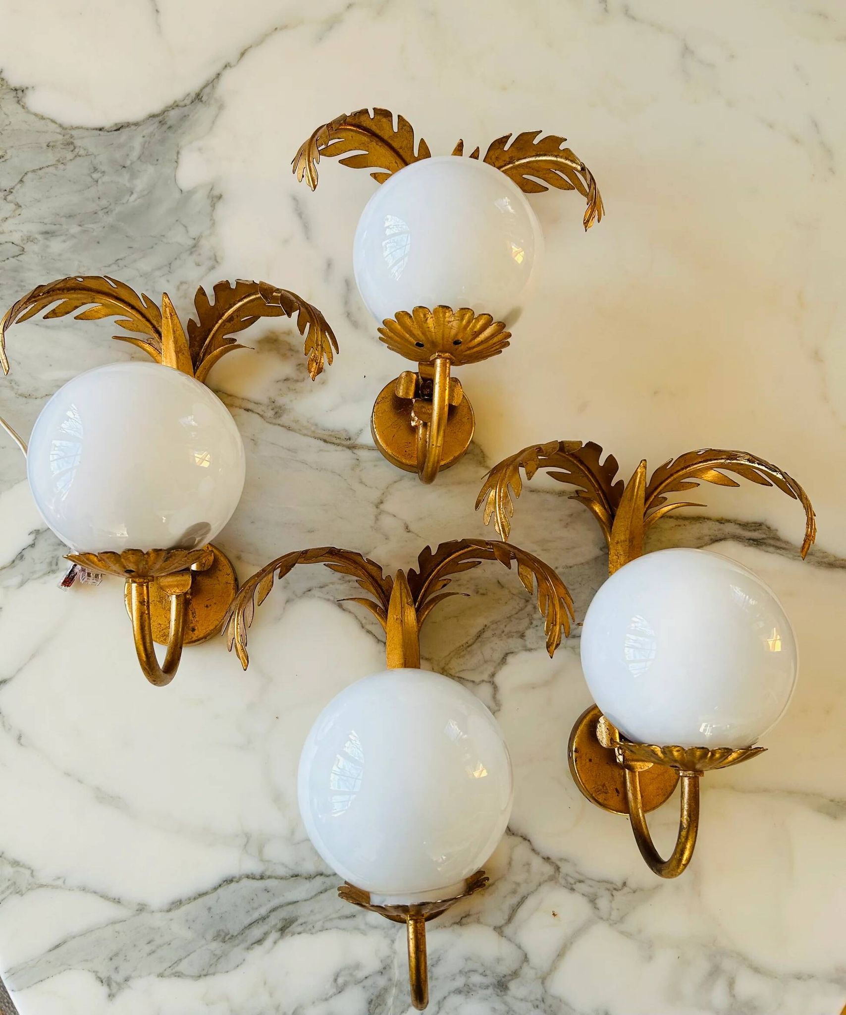 Pair of palm leaf wall lights in Hollywood Regency style with opaque globes by Hans Kögl, Germany, 1970s.