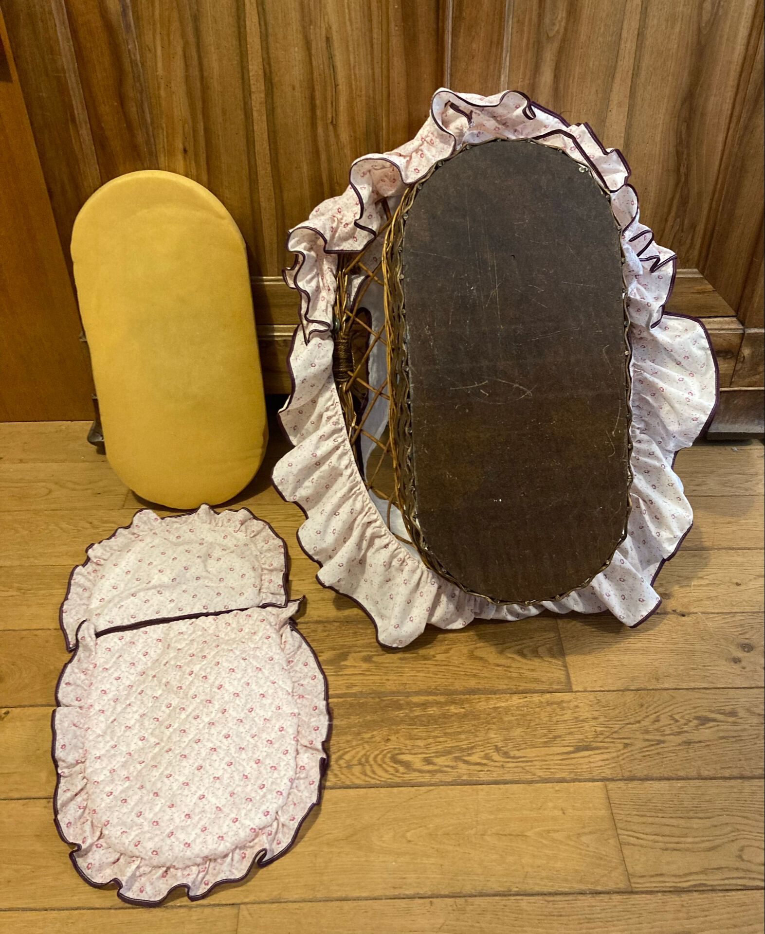 1960s wicker cradle with mattress and drapes.
