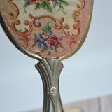 Antique hand mirror with stitched glass