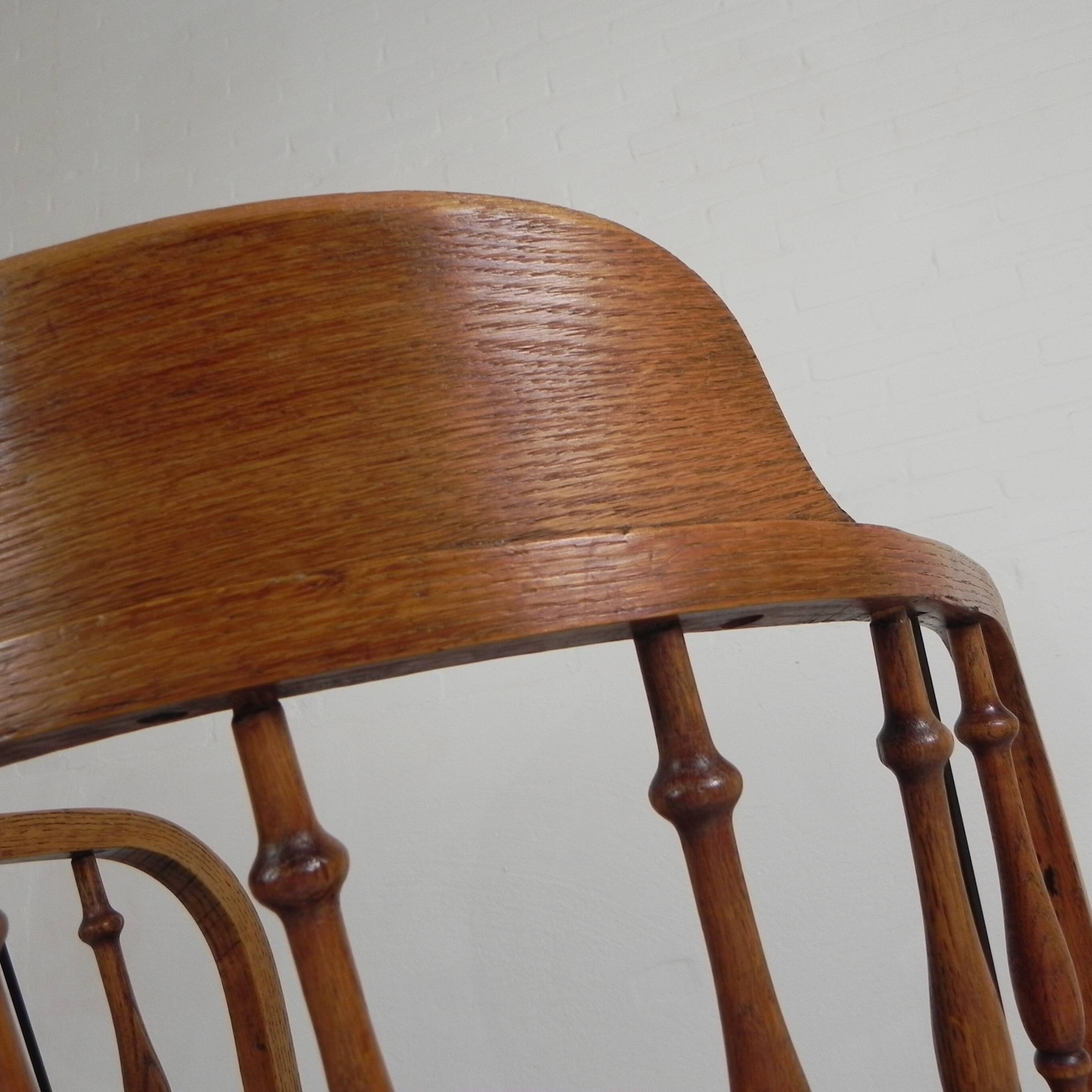 Oak office chair with a spring system and height adjustable, 1930s.