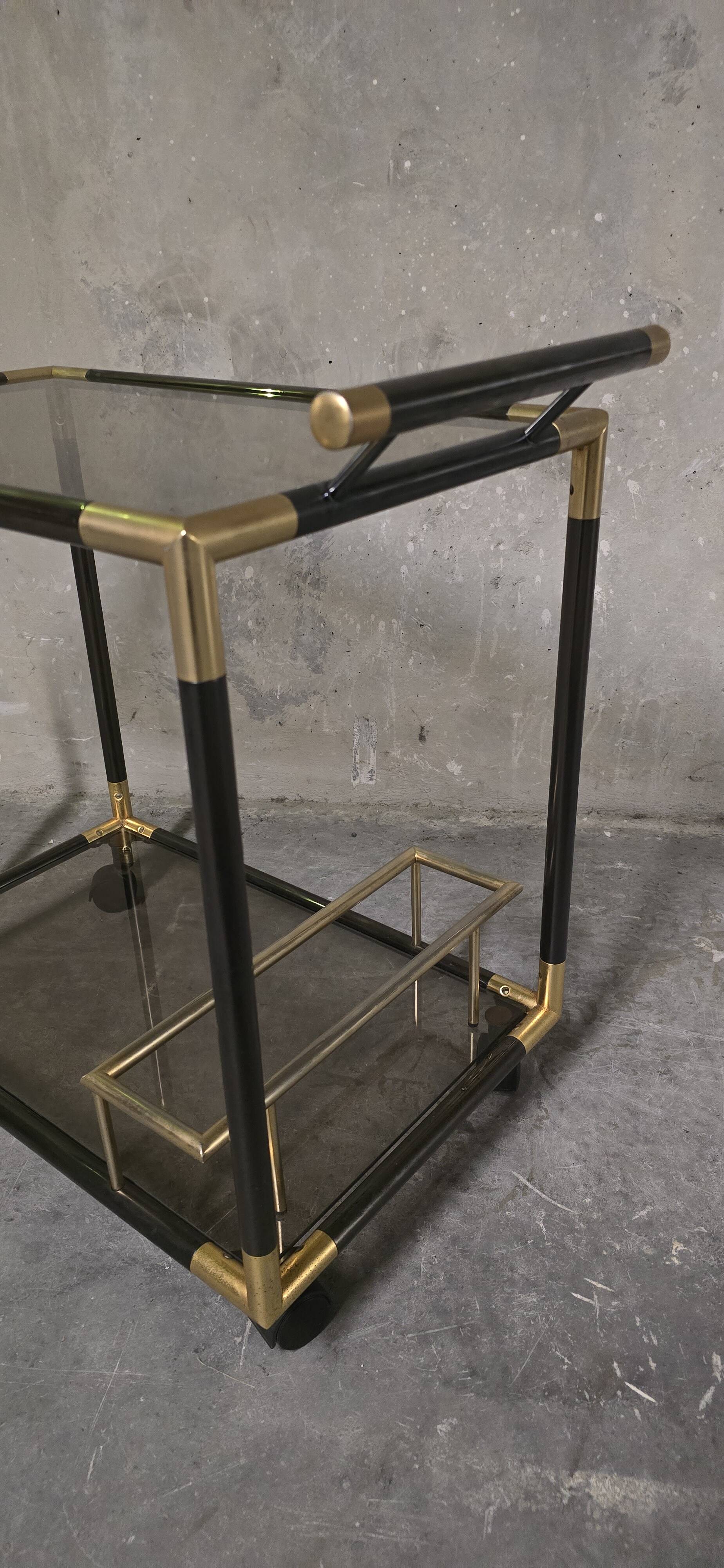 Black metal and brass rolling dessert trolley, smoked glass, 1970s.