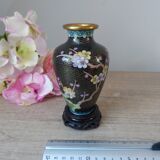Small black cloisonné vase decorated with yellow and pink cherry blossoms, vase on wooden base