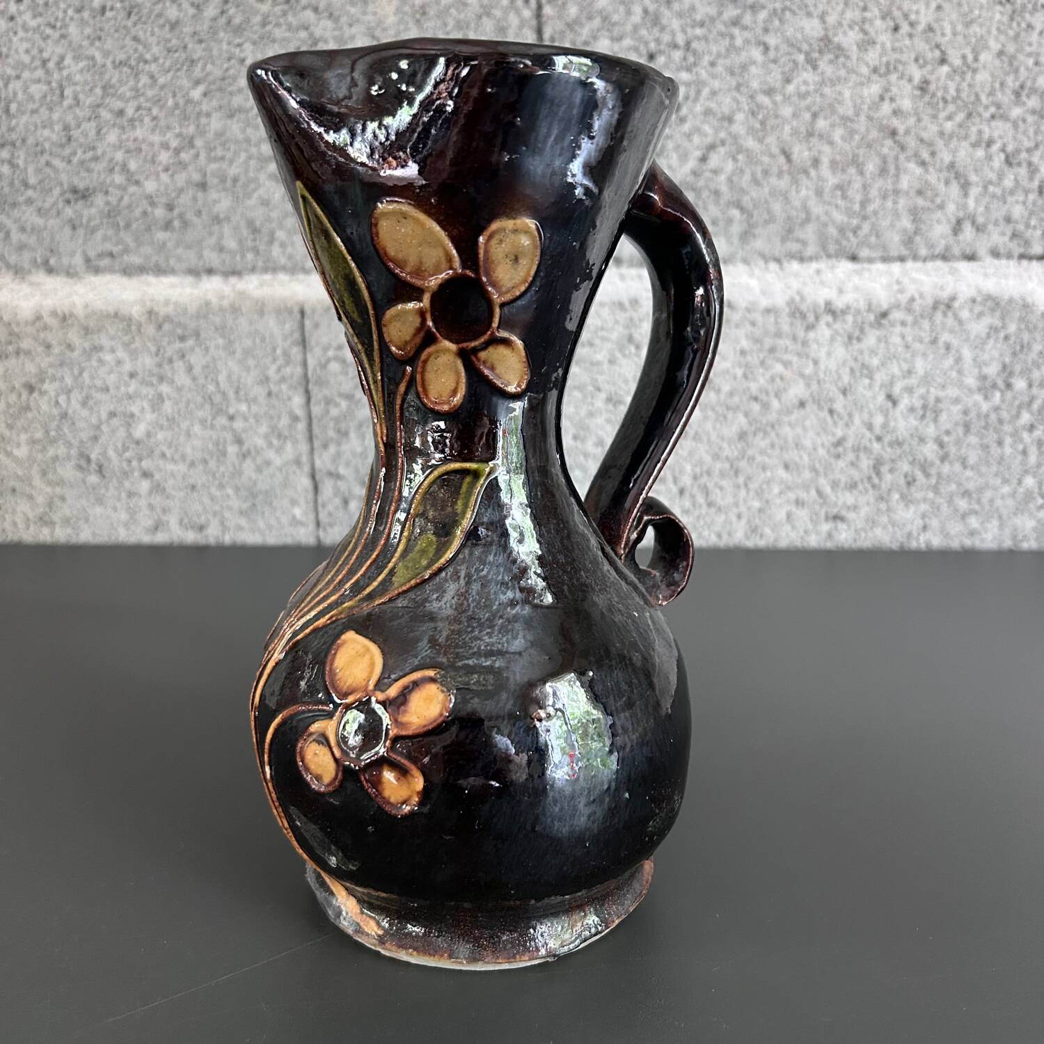Black vase with yellow flowers