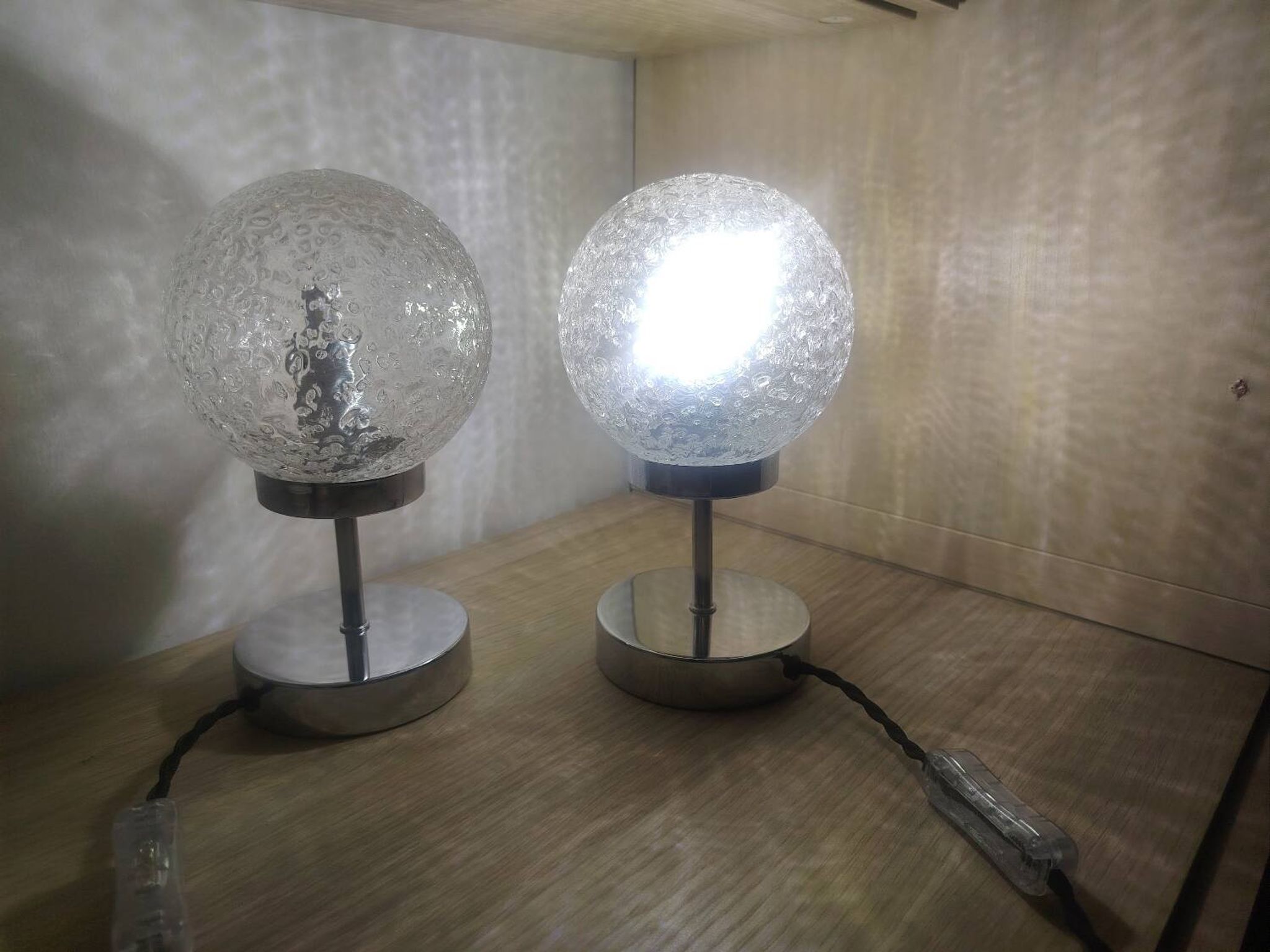 Duo of textured globe lamps with a large play of light.