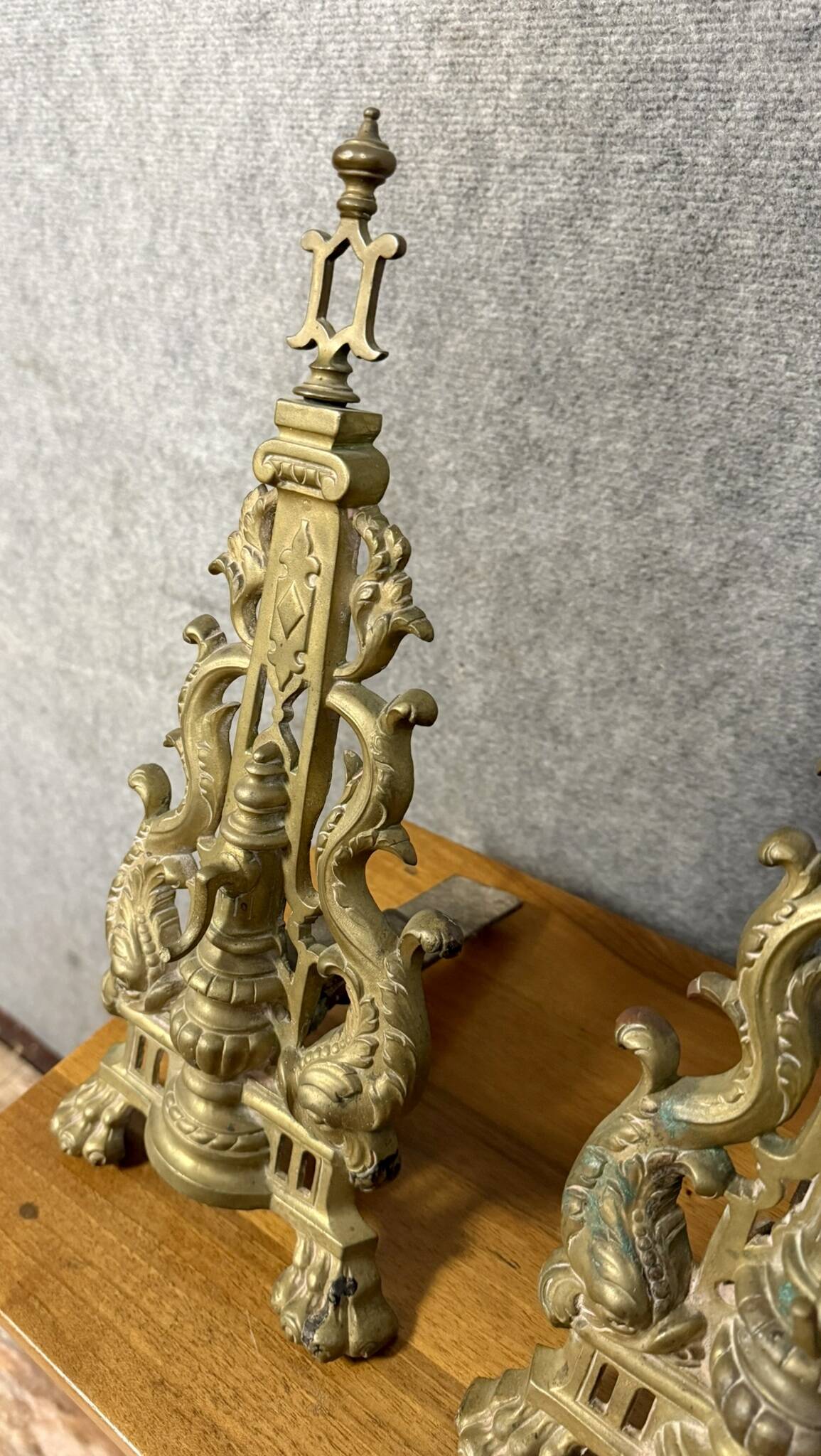 pair of Empire period dolphin firedogs in gilded bronze