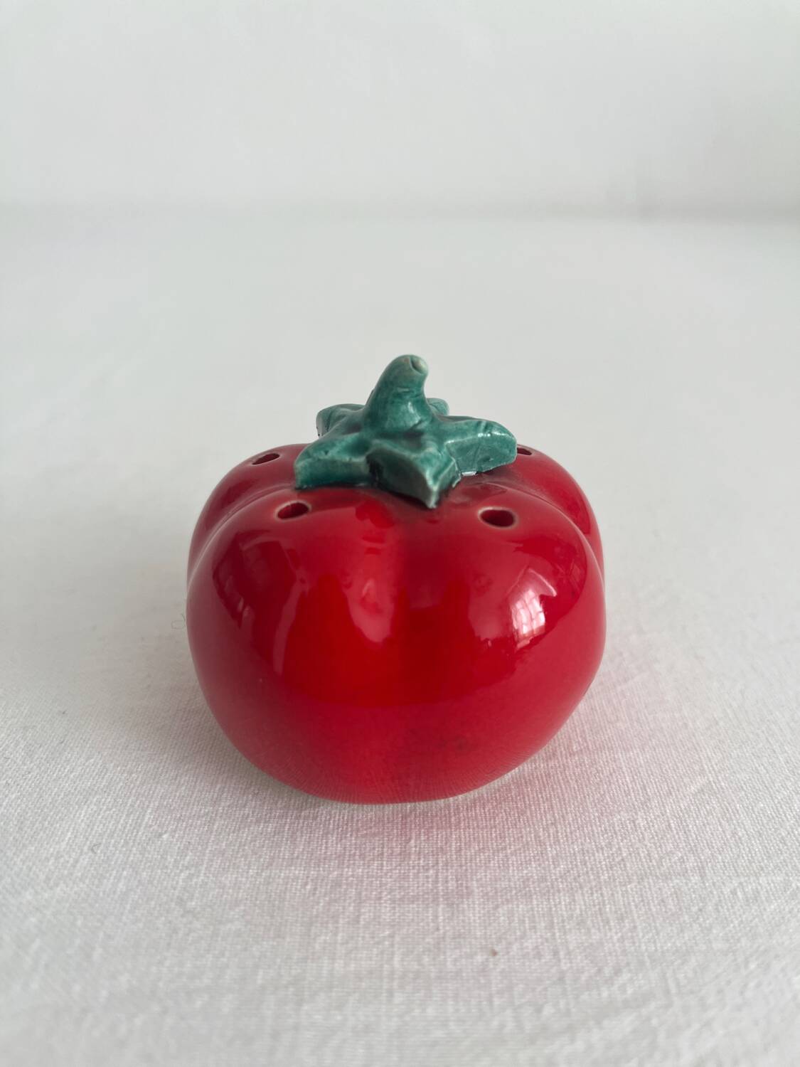 Vintage tomato salt or pepper shaker in slip
