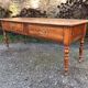 Antique cherry farmhouse table with turned legs and 2 drawers.