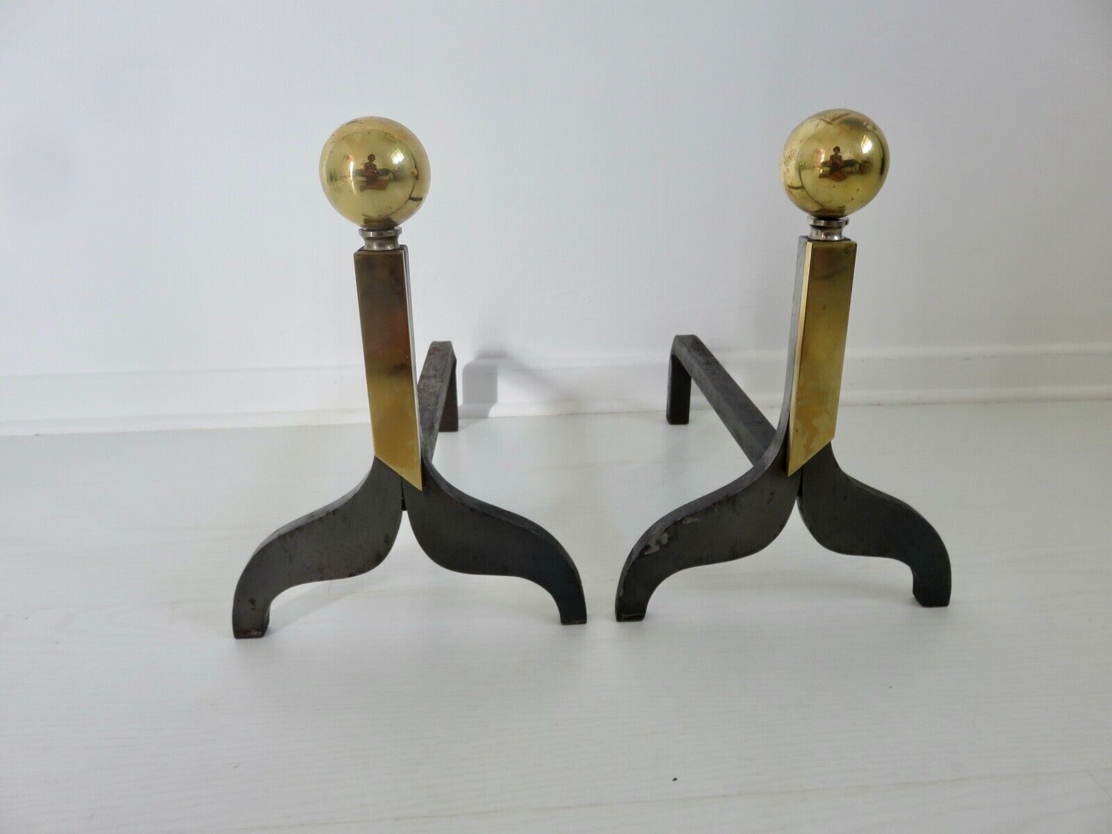 Pair of modernist steel and brass andirons